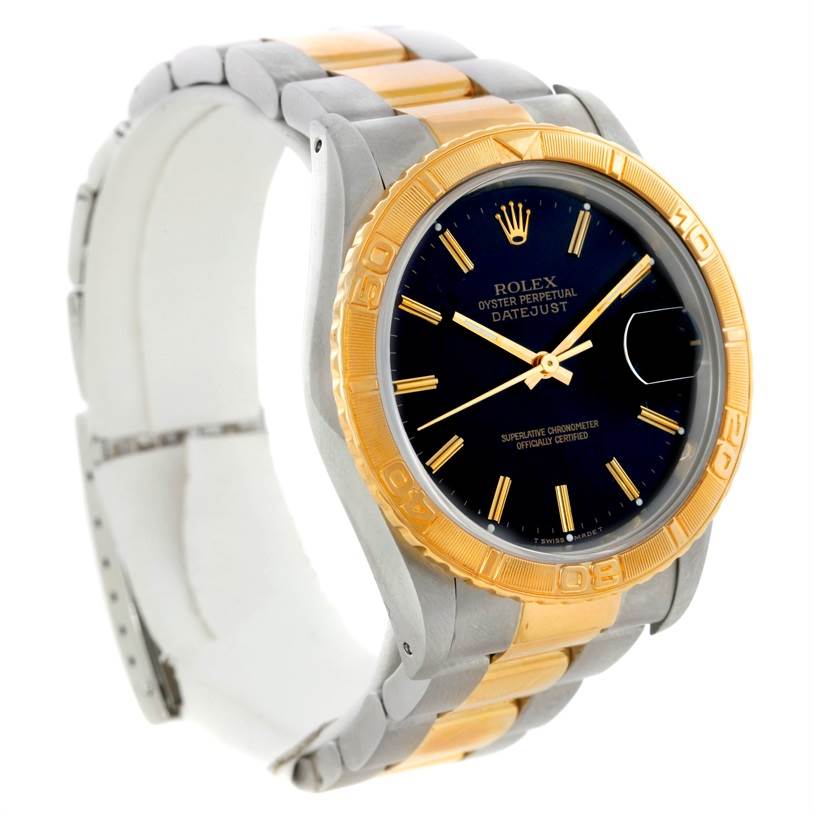 This image shows a Rolex Turn-o-Graph 16263 Men's Steel and Gold (two tone) Black Dial 16263 Men's Steel and Gold (two tone) Black Dial watch at an angle highlighting its gold bezel, black dial, and two-tone bracelet.