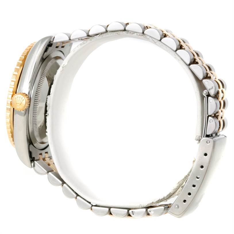 This side profile of the Rolex Turn-o-Graph 16263 Men's Steel and Gold (two tone) Beige Dial 16263 Men's Steel and Gold (two tone) Beige Dial model shows its bezel, crown, and a portion of its metal bracelet.