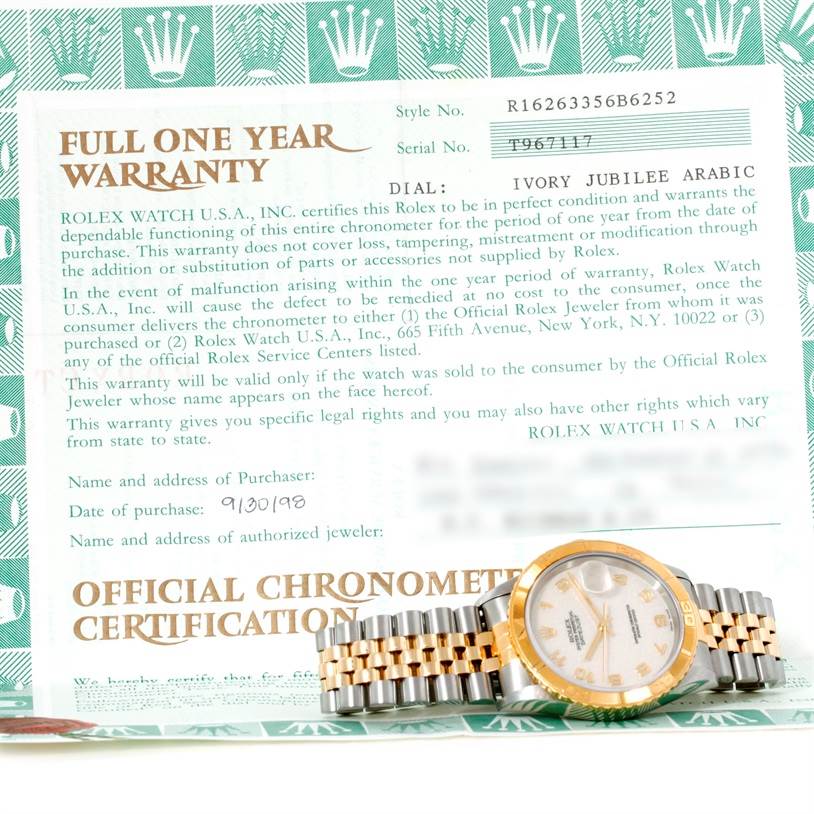 The image shows a Turn-o-Graph model by Rolex resting on top of its official warranty and certification document.