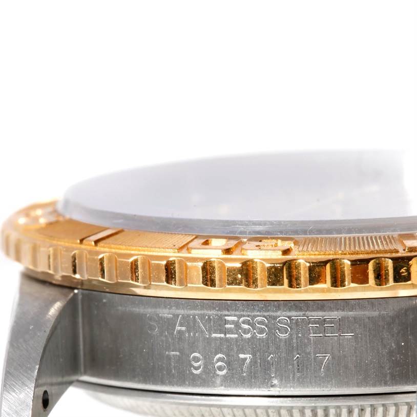 This image of the Rolex Turn-o-Graph 16263 Men's Steel and Gold (two tone) Beige Dial 16263 Men's Steel and Gold (two tone) Beige Dial watch shows a close-up of the side, highlighting the bezel, crystal, and part of the stainless steel case.