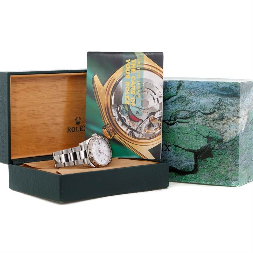 The Rolex Turn-o-Graph 116264 Men
s Stainless Steel White Dial 116264 Men
s Stainless Steel White Dial watch is shown in an open green box with the manual and outer packaging visible.