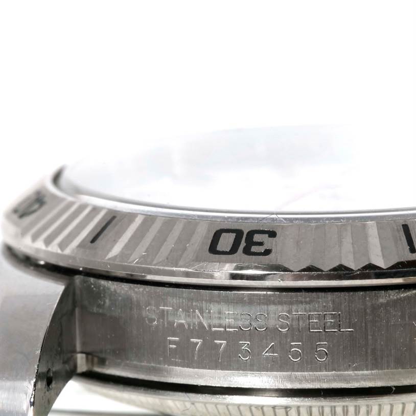 This close-up image of a Rolex Turn-o-Graph 116264 Men
s Stainless Steel White Dial 116264 Men
s Stainless Steel White Dial model shows the side angle, bezel, and part of the case with engraving.