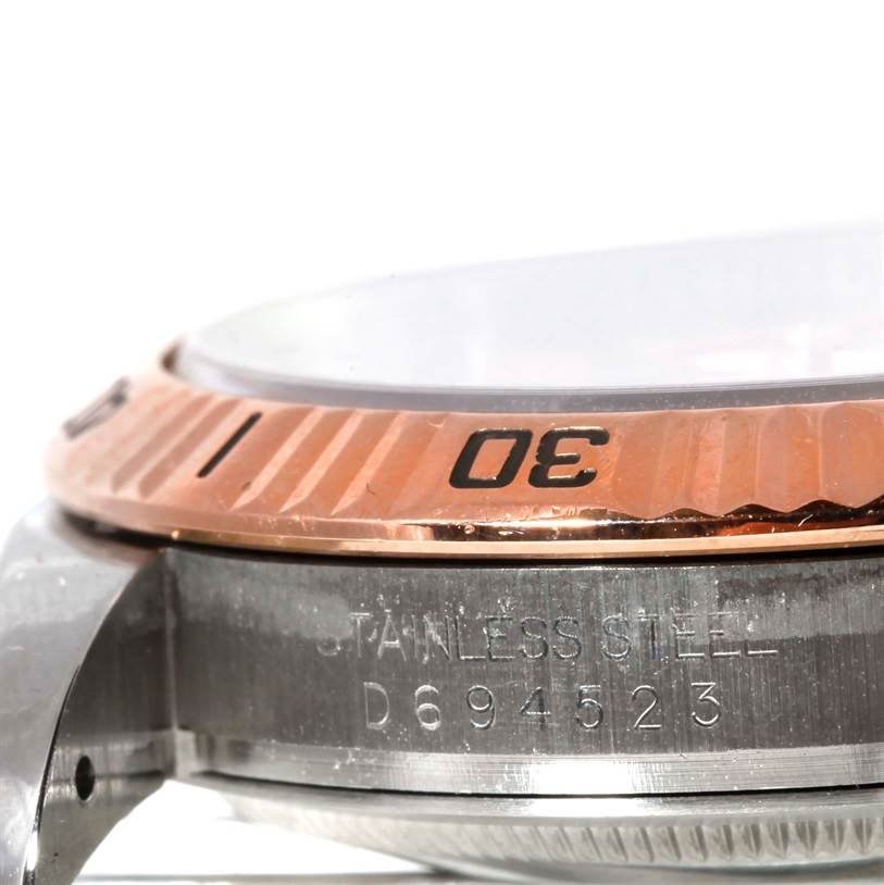 This close-up image of the Rolex Turn-o-Graph 116261 Men
s Stainless Steel Silver Dial 116261 Men
s Stainless Steel Silver Dial model shows the bezel and part of the case, with the serial number engraved on the side.