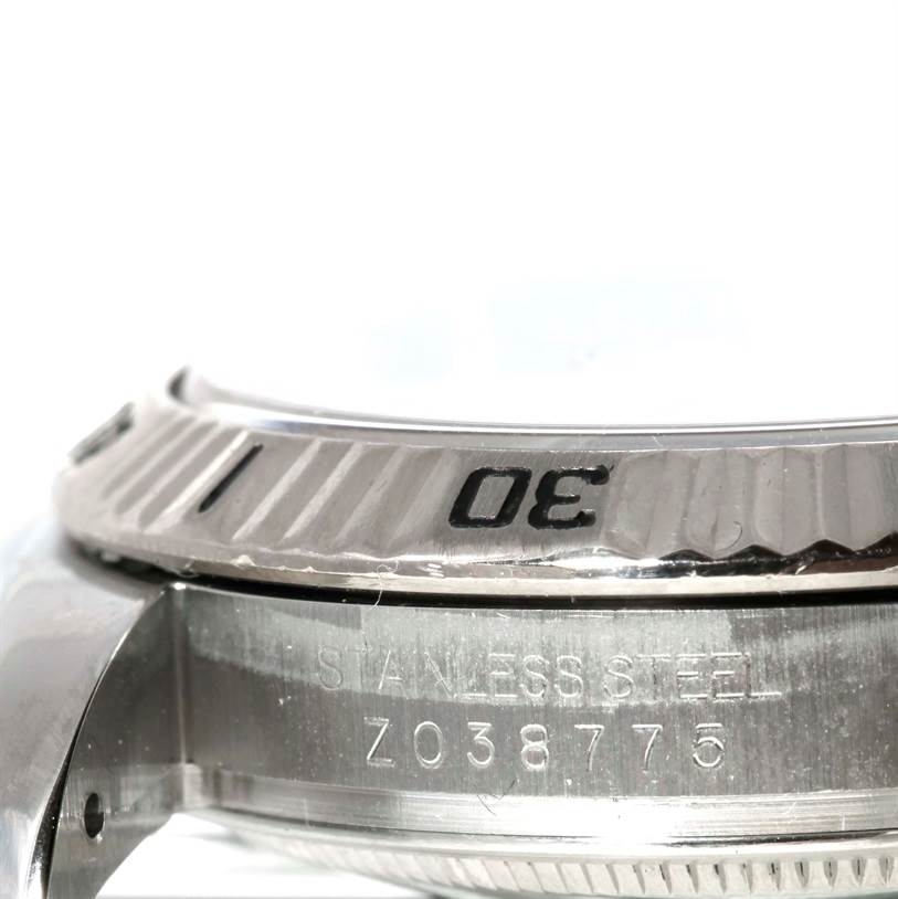 The image shows a close-up side angle of the bezel and case of the Rolex Turn-o-Graph 116264 Men's Stainless Steel White Dial 116264 Men's Stainless Steel White Dial watch.