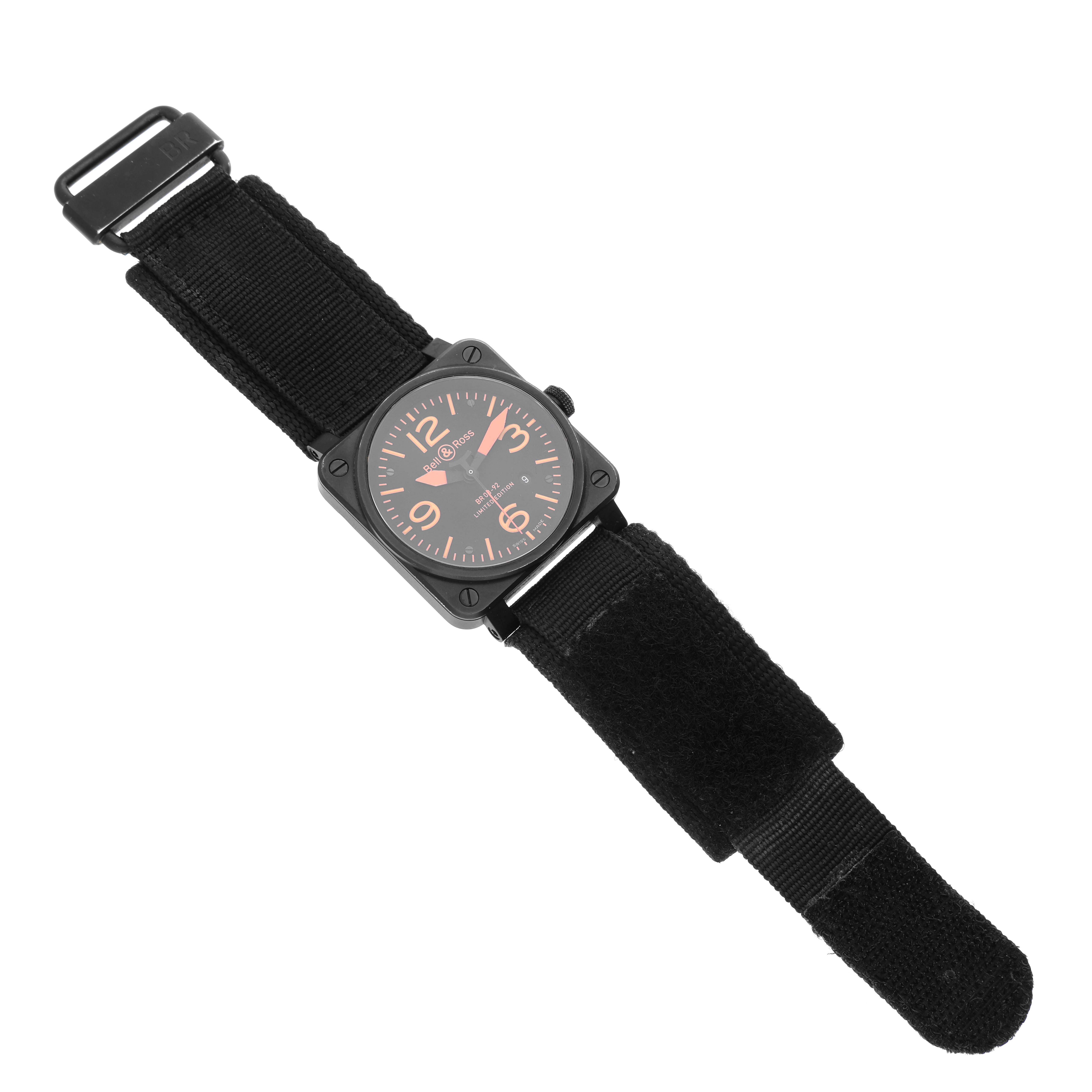 The image shows a Bell 
Ross Instruments BR03-92-S Men
s Stainless Steel Black Dial BR03-92-S Men
s Stainless Steel Black Dial model watch with a black square face and black fabric strap, viewed from above.