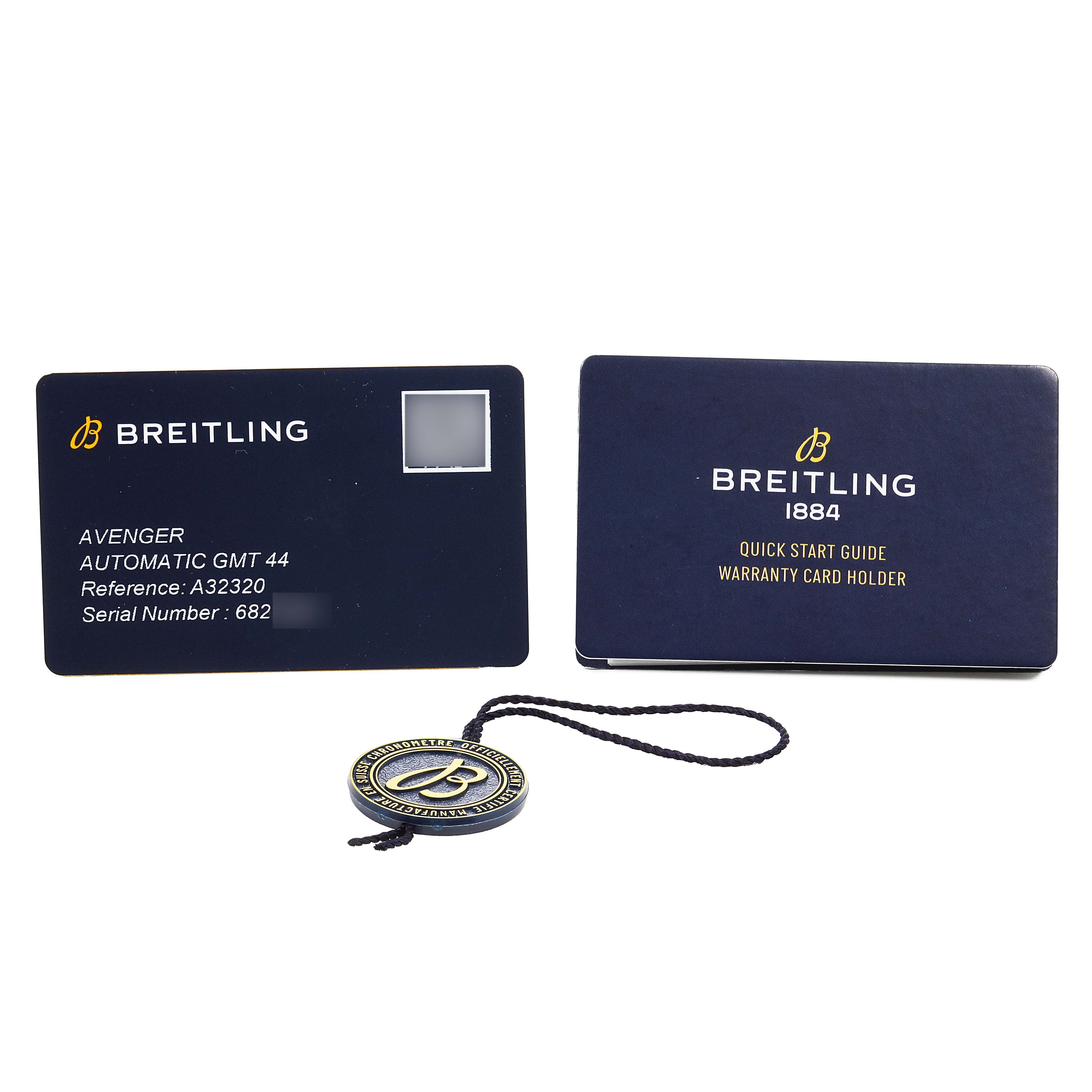 The image shows the Breitling Avenger A32320 Men's Stainless Steel Blue Dial's warranty card, quick start guide holder, and a branded tag.