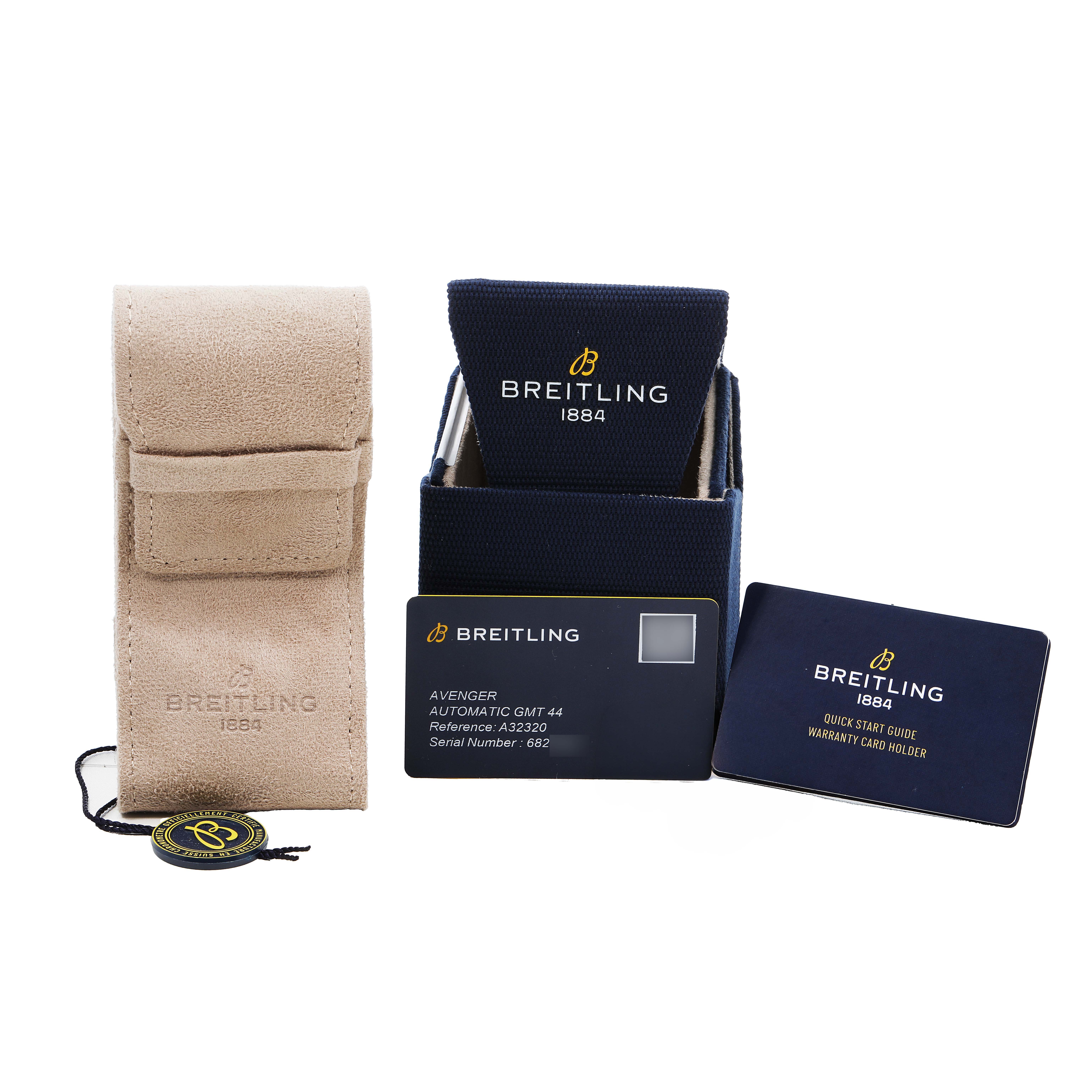 The image shows accessories for a Breitling Avenger A32320 Men's Stainless Steel Blue Dial watch, including a case, box, tags, and documentation.
