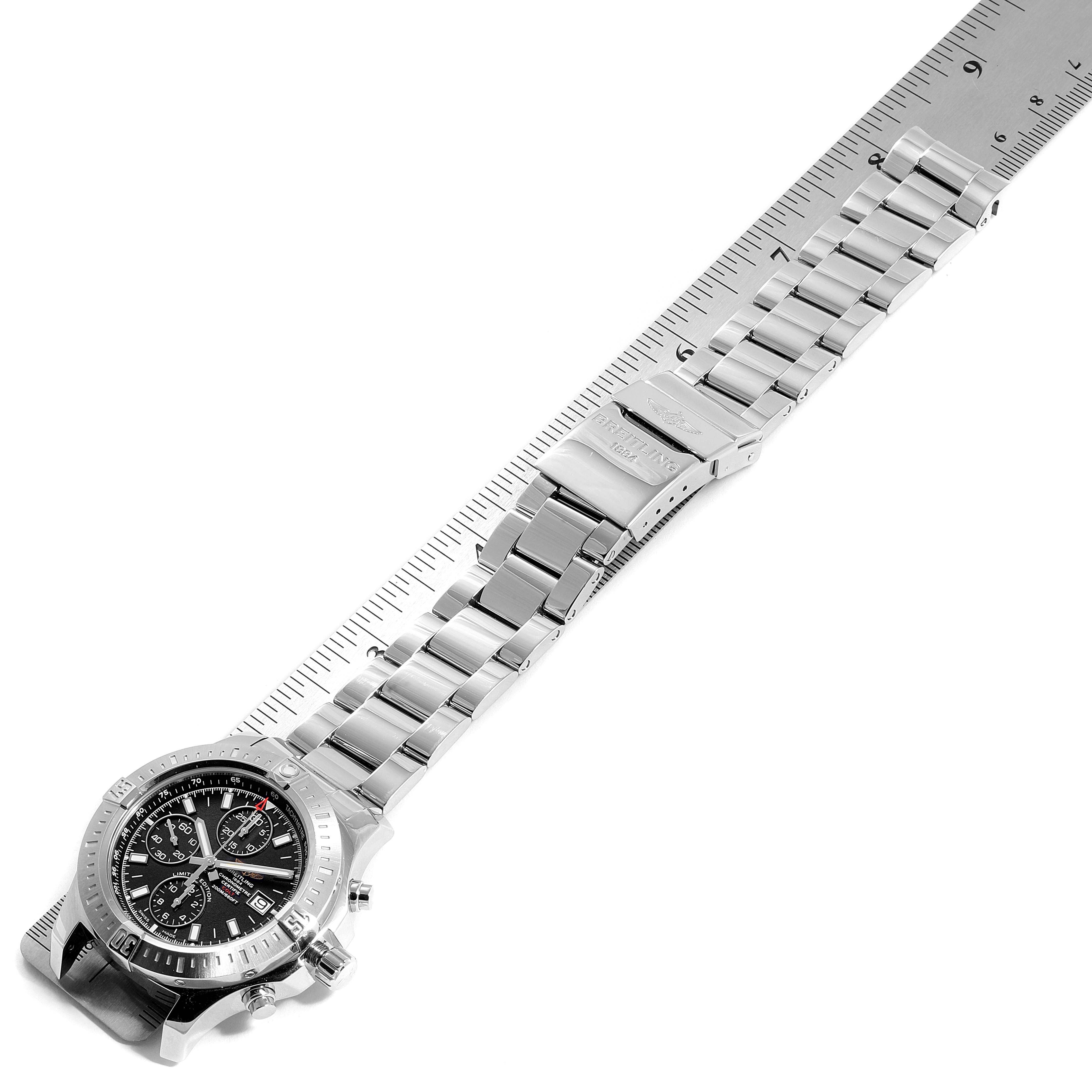 This image shows a top-down view of the Breitling Colt A13388 Men's Stainless Steel Black Dial A13388 Men's Stainless Steel Black Dial watch displaying its face, bezel, and metal bracelet alongside a ruler.