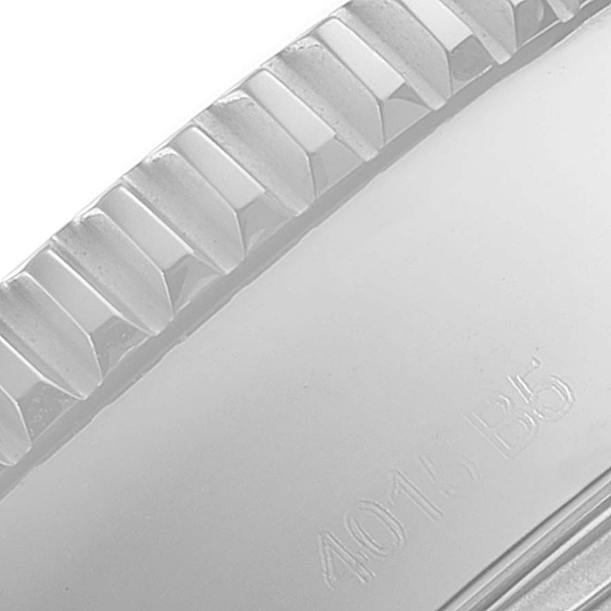 The image displays a close-up of the ridged bezel and part of the case back of a Breitling Superocean A17391 Men's Stainless Steel Blue Dial A17391 Men's Stainless Steel Blue Dial watch.