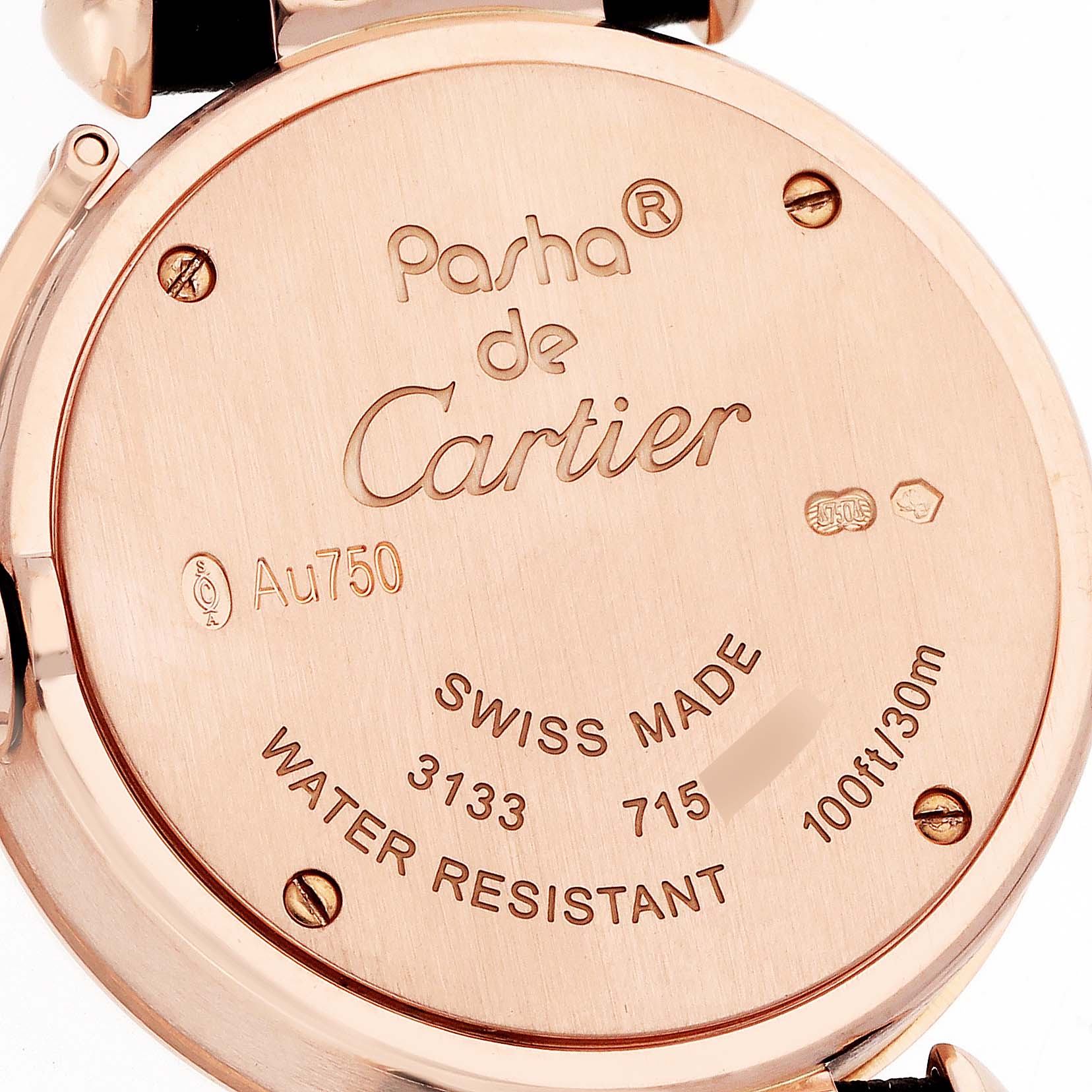 The image shows the back case of a Pasha model by Cartier, highlighting engravings and water resistance details.