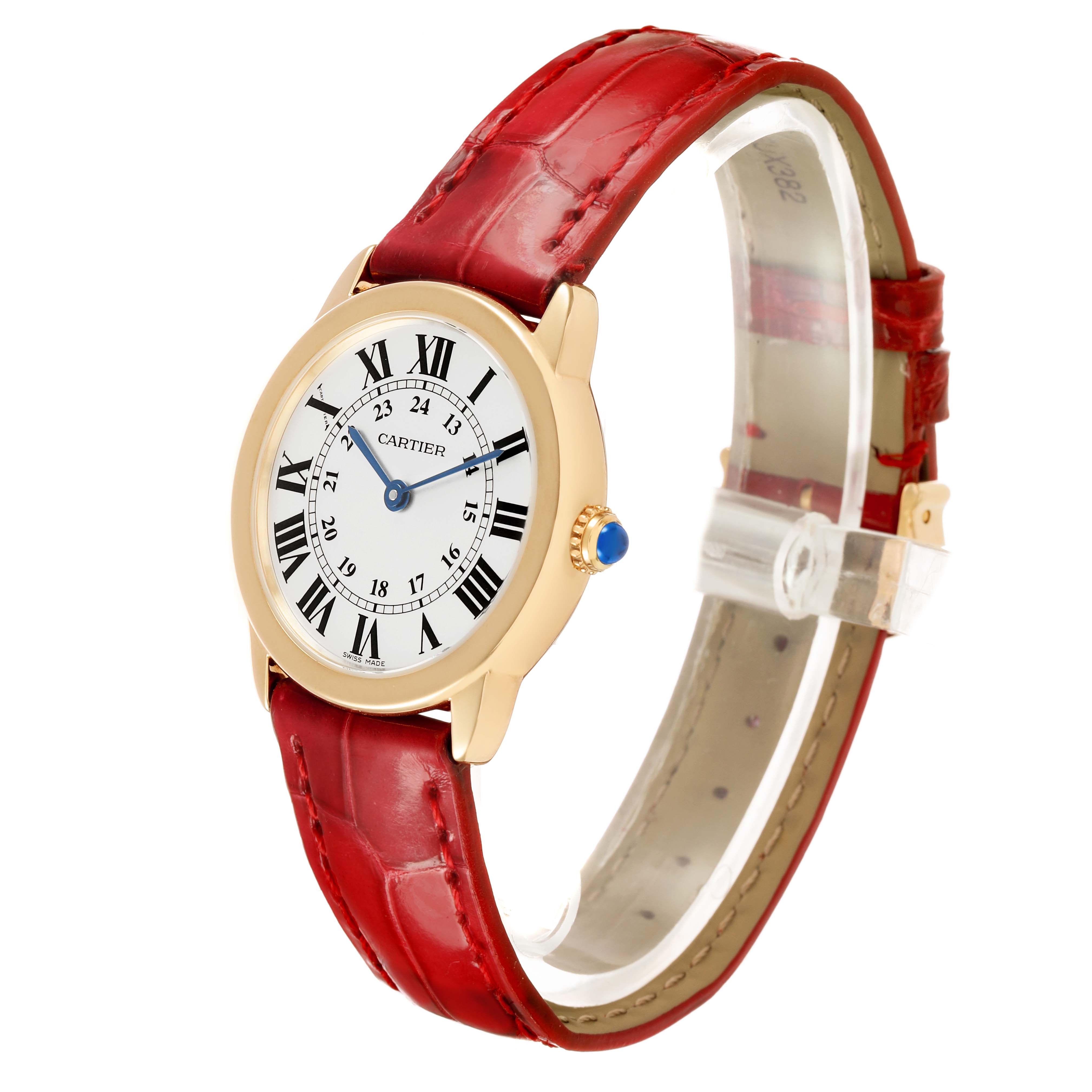 The Cartier Ronde W6700355 Women's Yellow Gold Silver Dial watch is shown at a three-quarter angle highlighting its round face, Roman numerals, blue hands, and red leather strap.