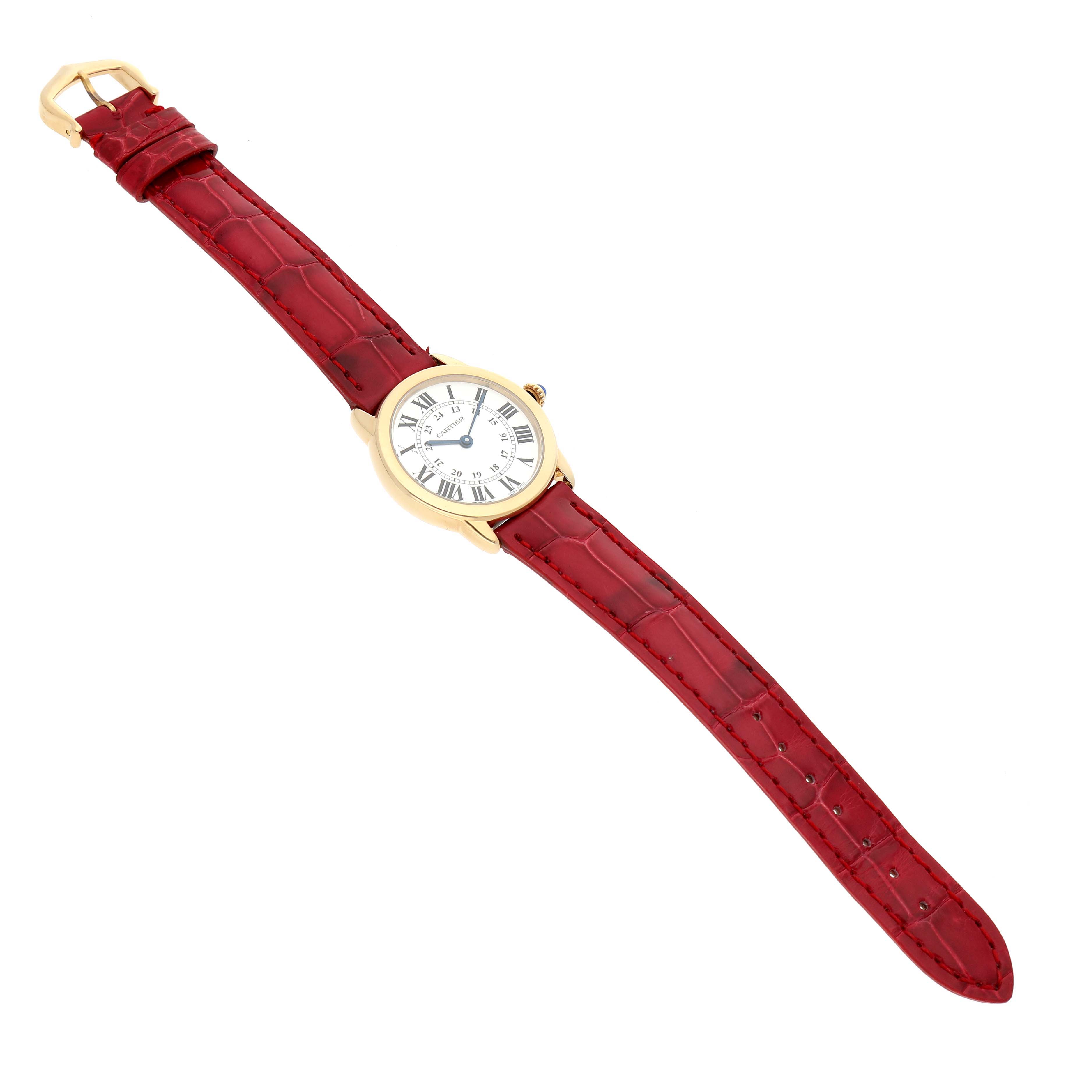 The Cartier Ronde W6700355 Women's Yellow Gold Silver Dial watch is shown from a top angle, displaying the face with Roman numerals, gold case, and red leather strap.