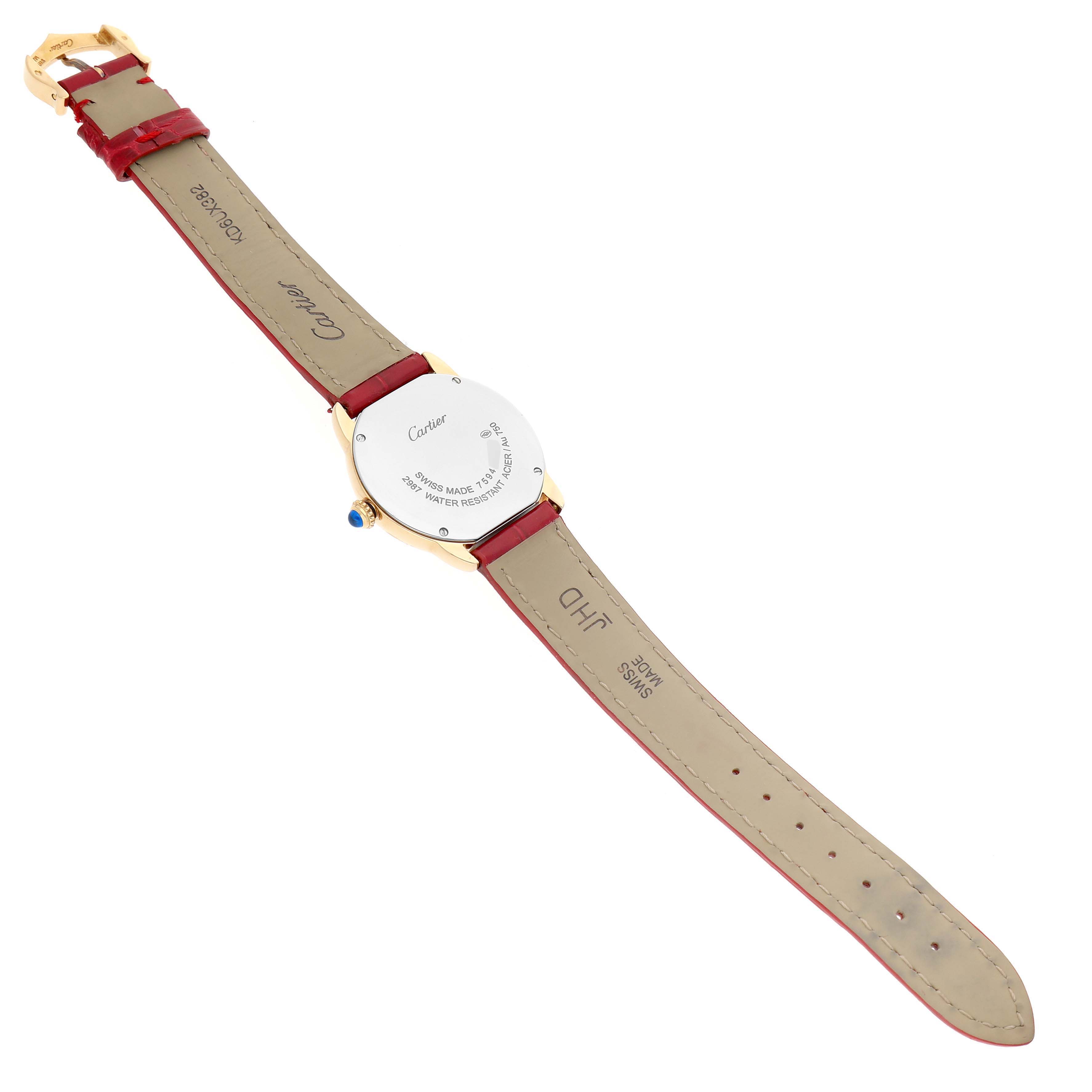 The image shows the back view of a Cartier Ronde W6700355 Women's Yellow Gold Silver Dial watch, highlighting the case back, leather strap, and clasp.