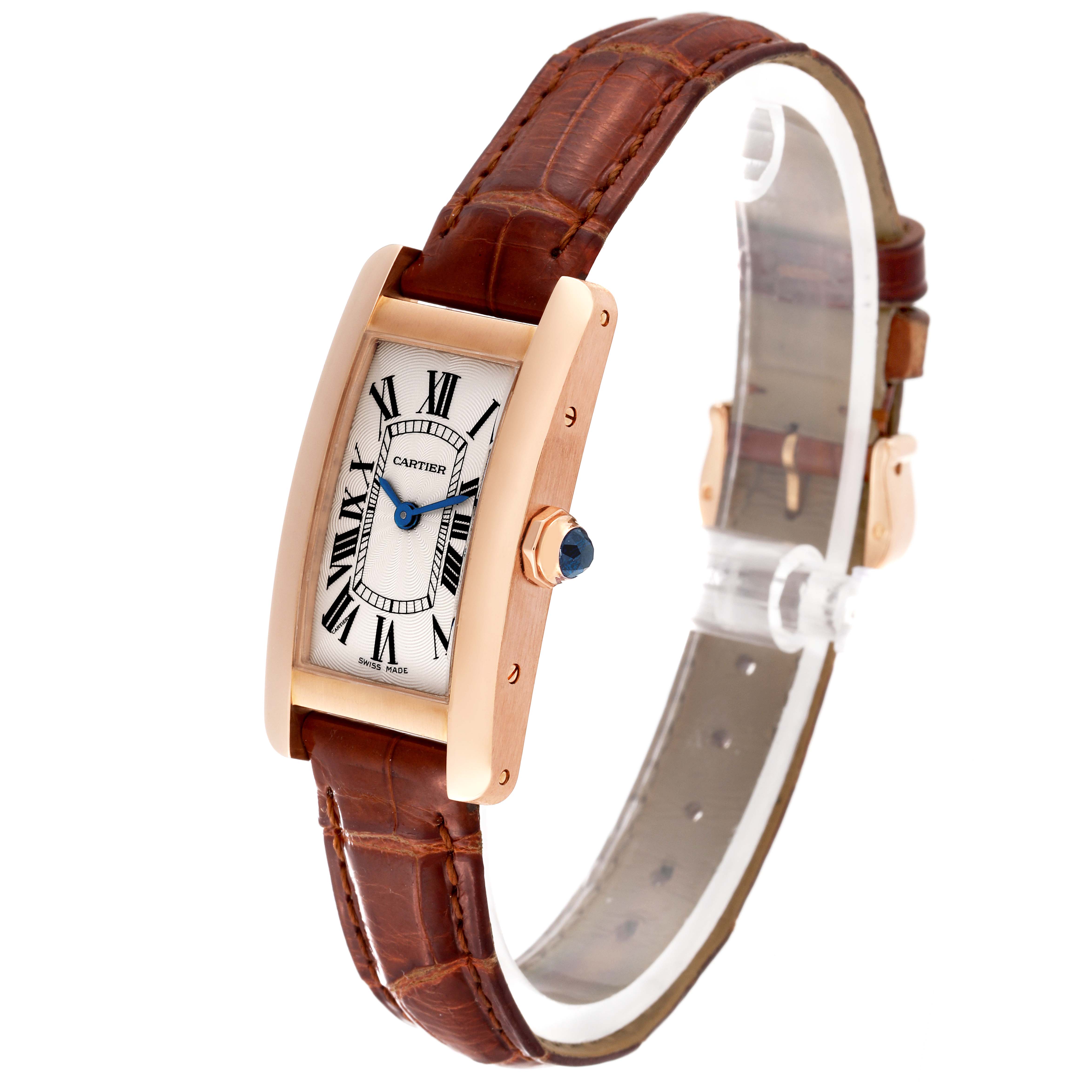 The image shows a Cartier Tank Americaine W2607456 Women's Rose Gold Silver Dial W2607456 Women's Rose Gold Silver Dial watch at a side angle, highlighting the brown leather strap, rectangular face, and blue hands.