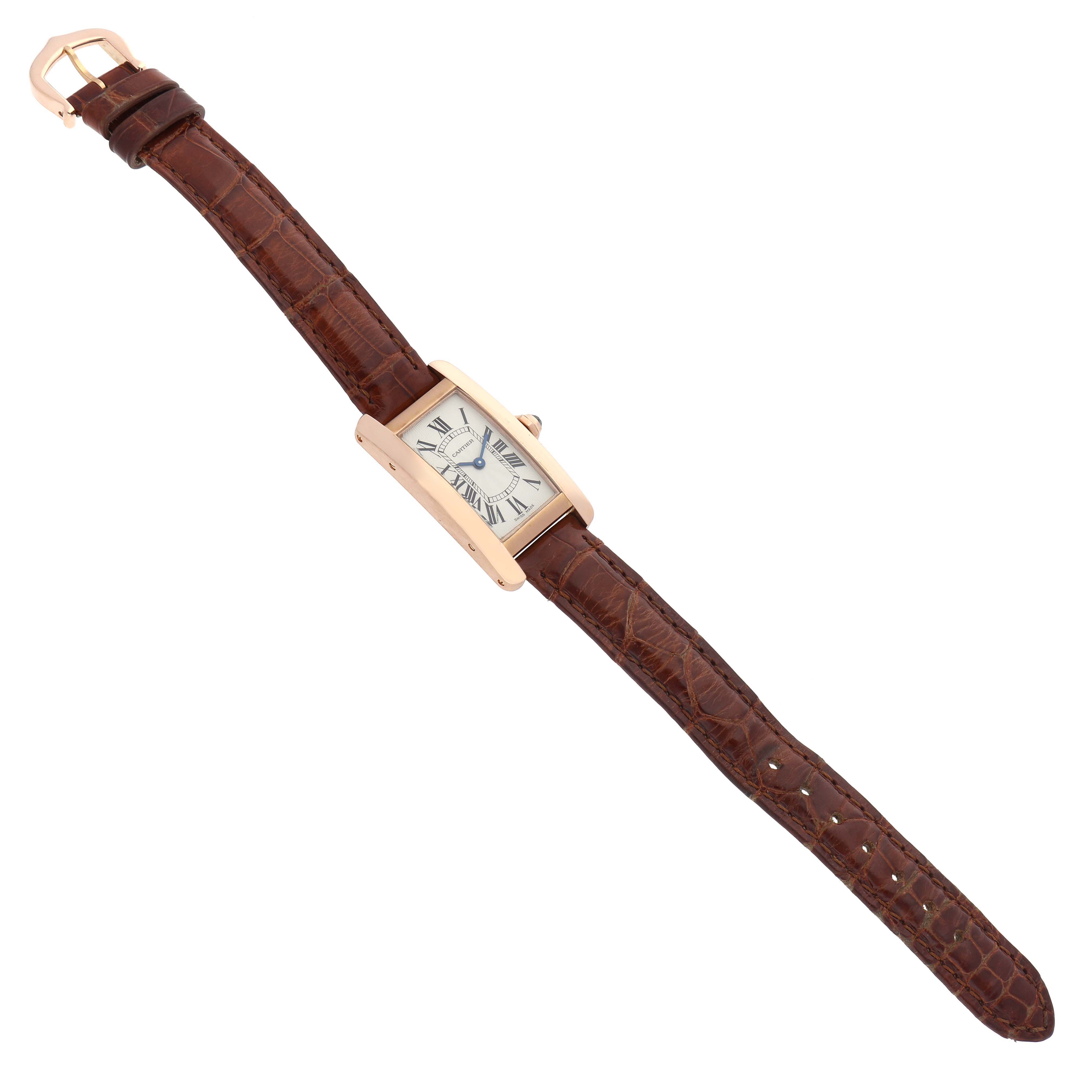 The Cartier Tank Americaine W2607456 Women's Rose Gold Silver Dial W2607456 Women's Rose Gold Silver Dial watch is shown from a slightly angled top view, displaying the face, brown leather strap, and gold buckle.
