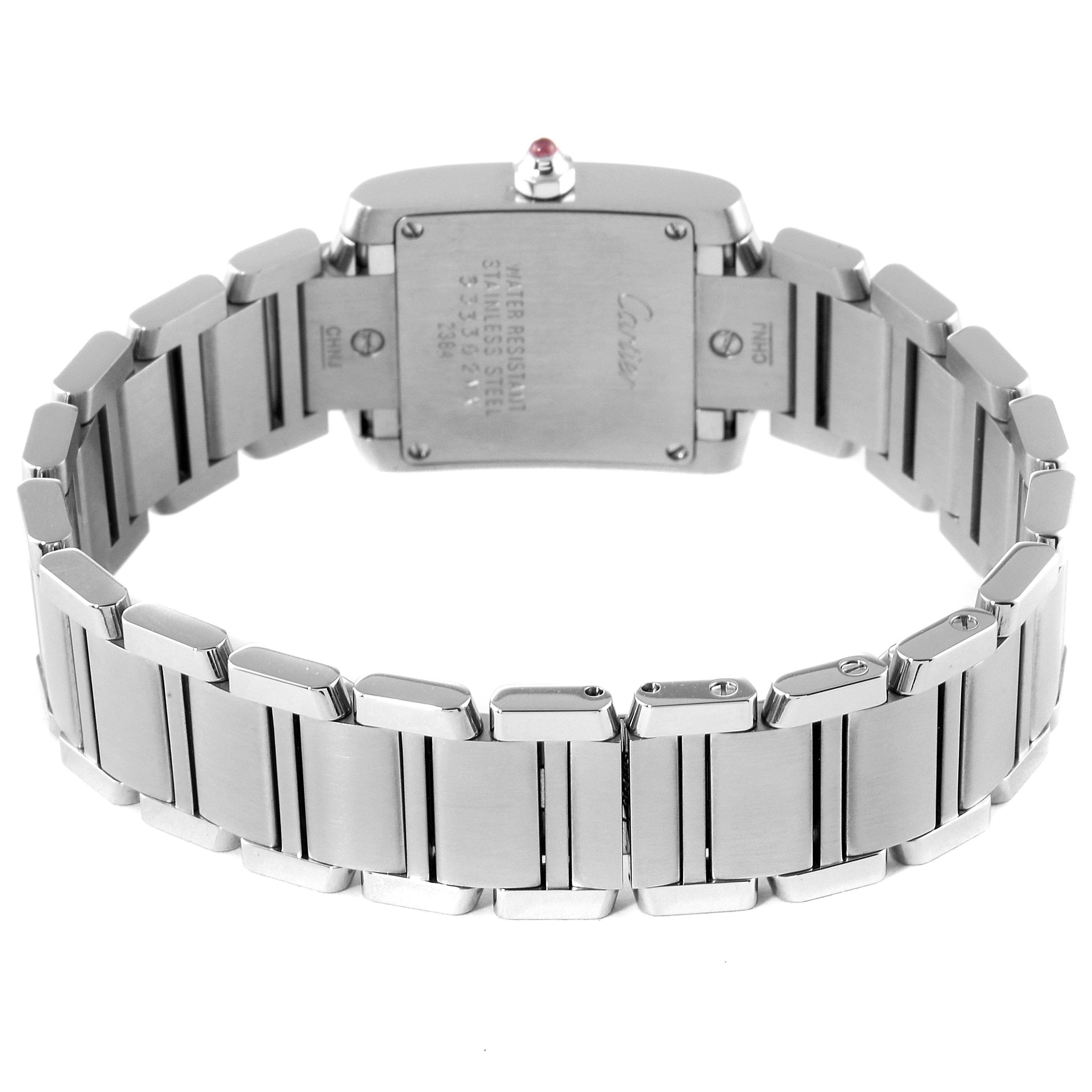 The image shows the back case and bracelet of a Cartier Tank Française watch, highlighting the stainless steel construction.