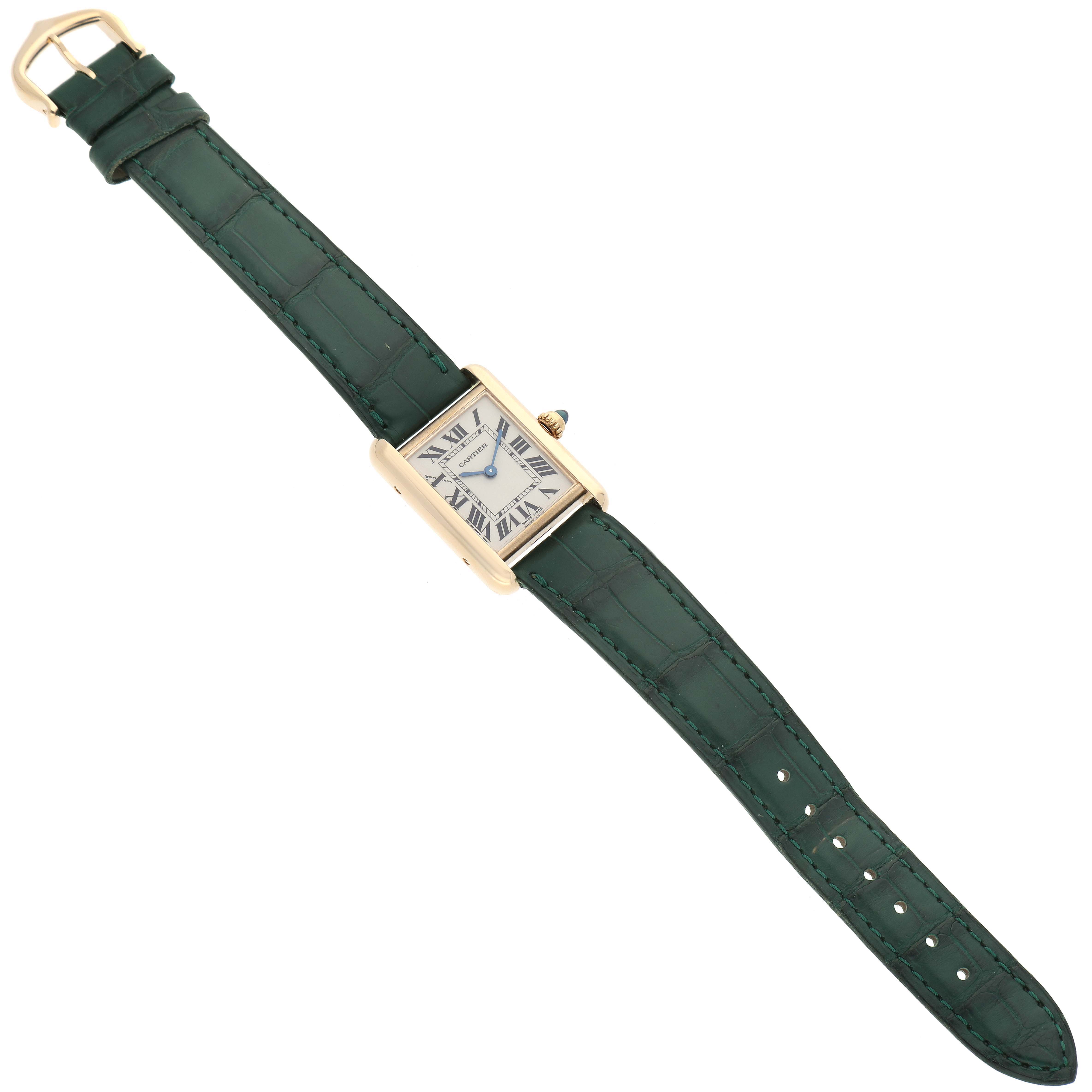 The Cartier Tank Louis W1529856 Women's Yellow Gold Silver Dial W1529856 Women's Yellow Gold Silver Dial watch is shown from a top-down angle, displaying its green leather strap and rectangular gold case.