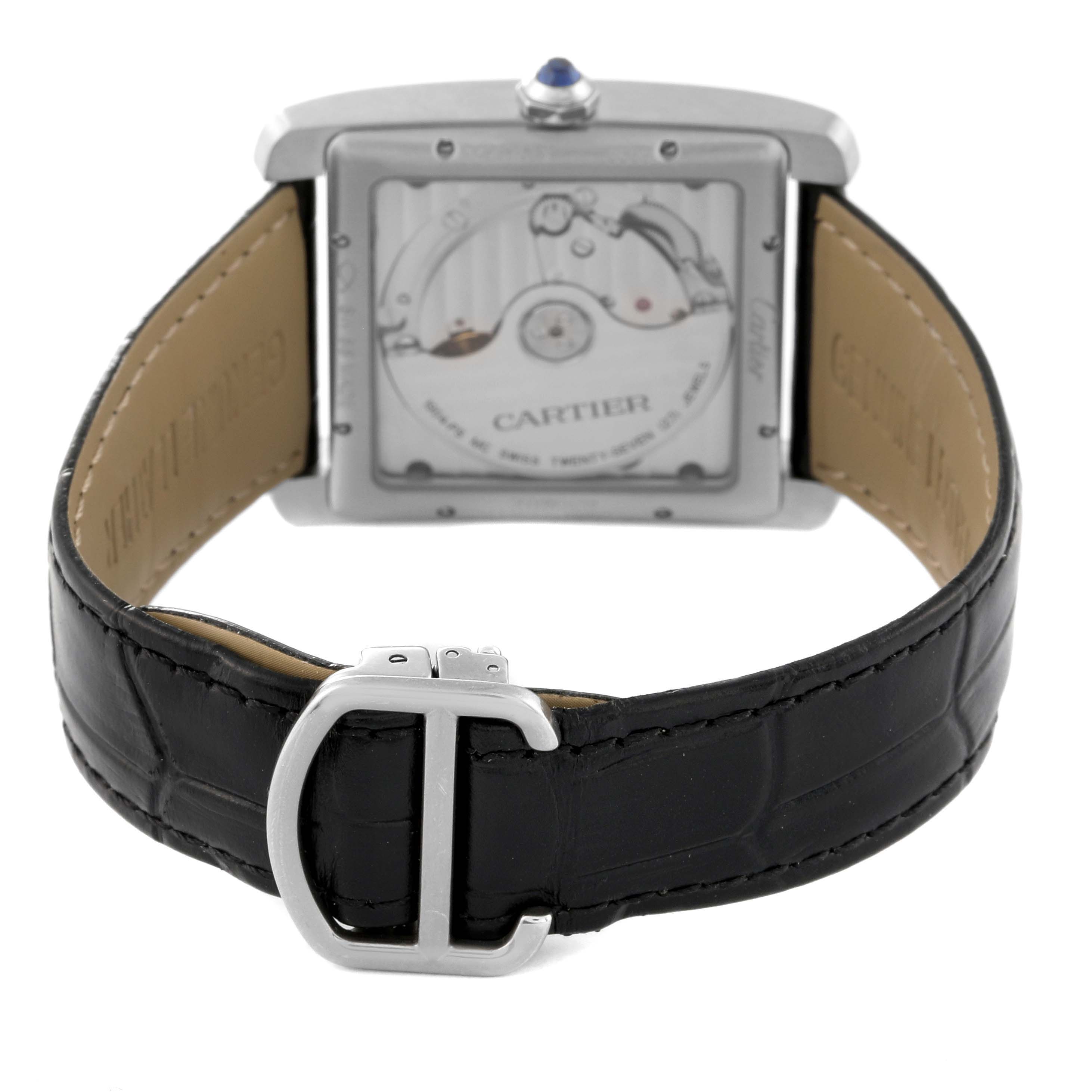The image shows the back view of a Cartier Tank MC W5330004 Men
s Stainless Steel Black Dial W5330004 Men
s Stainless Steel Black Dial watch, displaying its movement and black leather strap with a deployment buckle.
