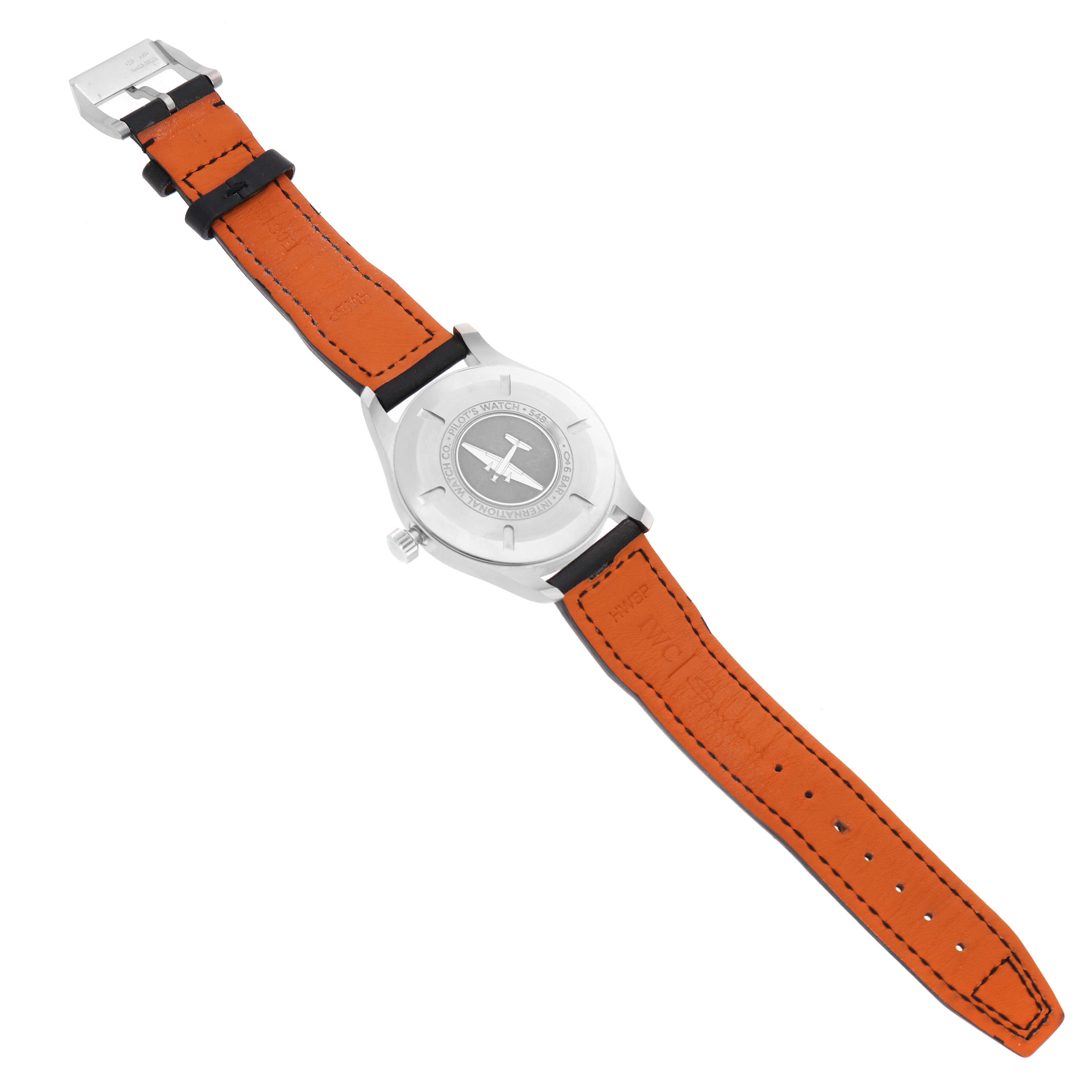 The image shows the back of the IWC Pilot IW327001 Men's Stainless Steel Black Dial model watch, highlighting the case back and orange leather strap.