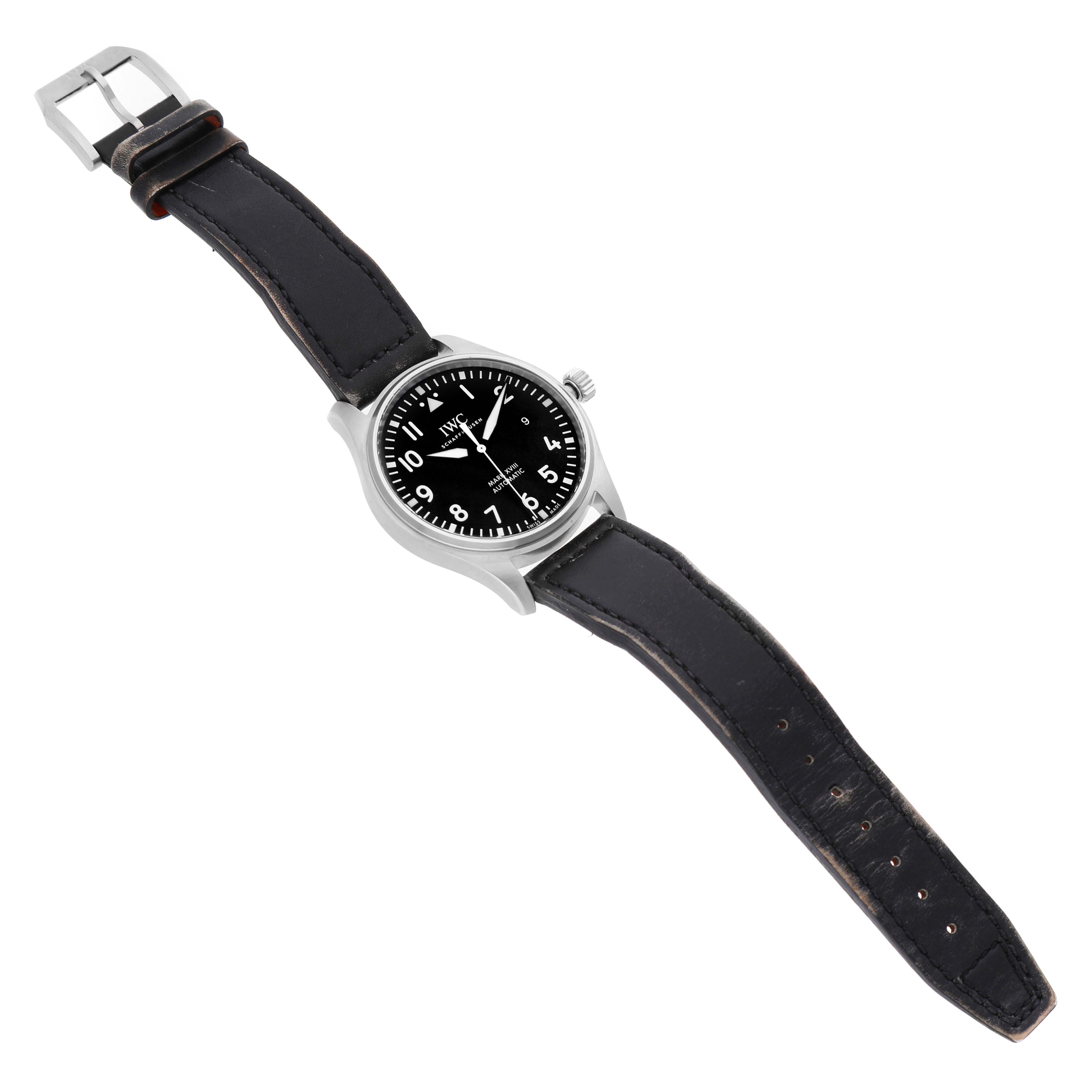 The IWC Pilot IW327001 Men's Stainless Steel Black Dial model watch is shown at a tilted angle, displaying its face, bezel, crown, and full leather strap.