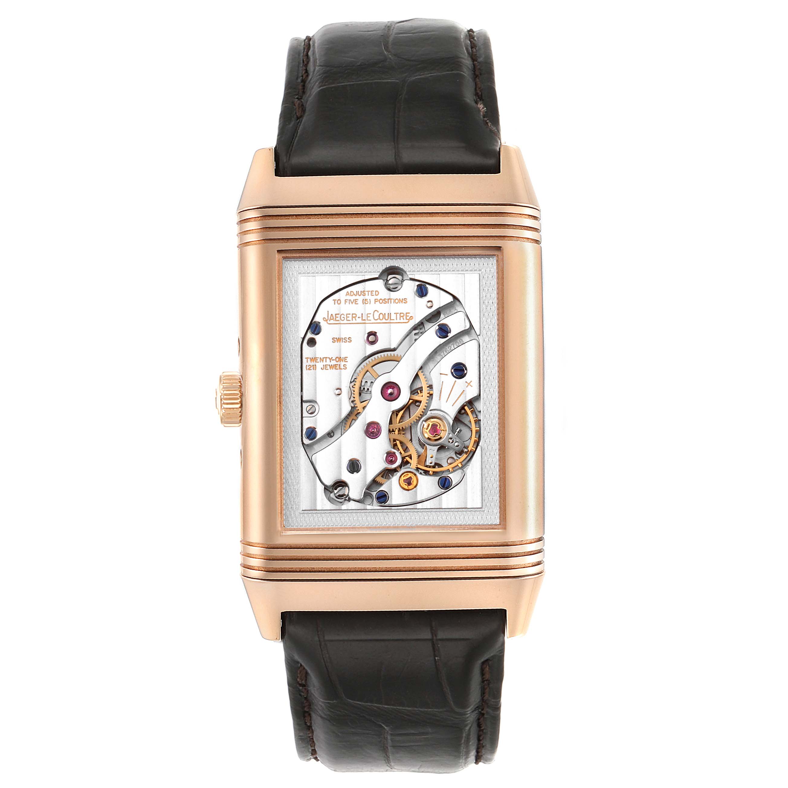 The image shows a Jaeger-LeCoultre Reverso watch from the front, highlighting its mechanical movement and leather strap.