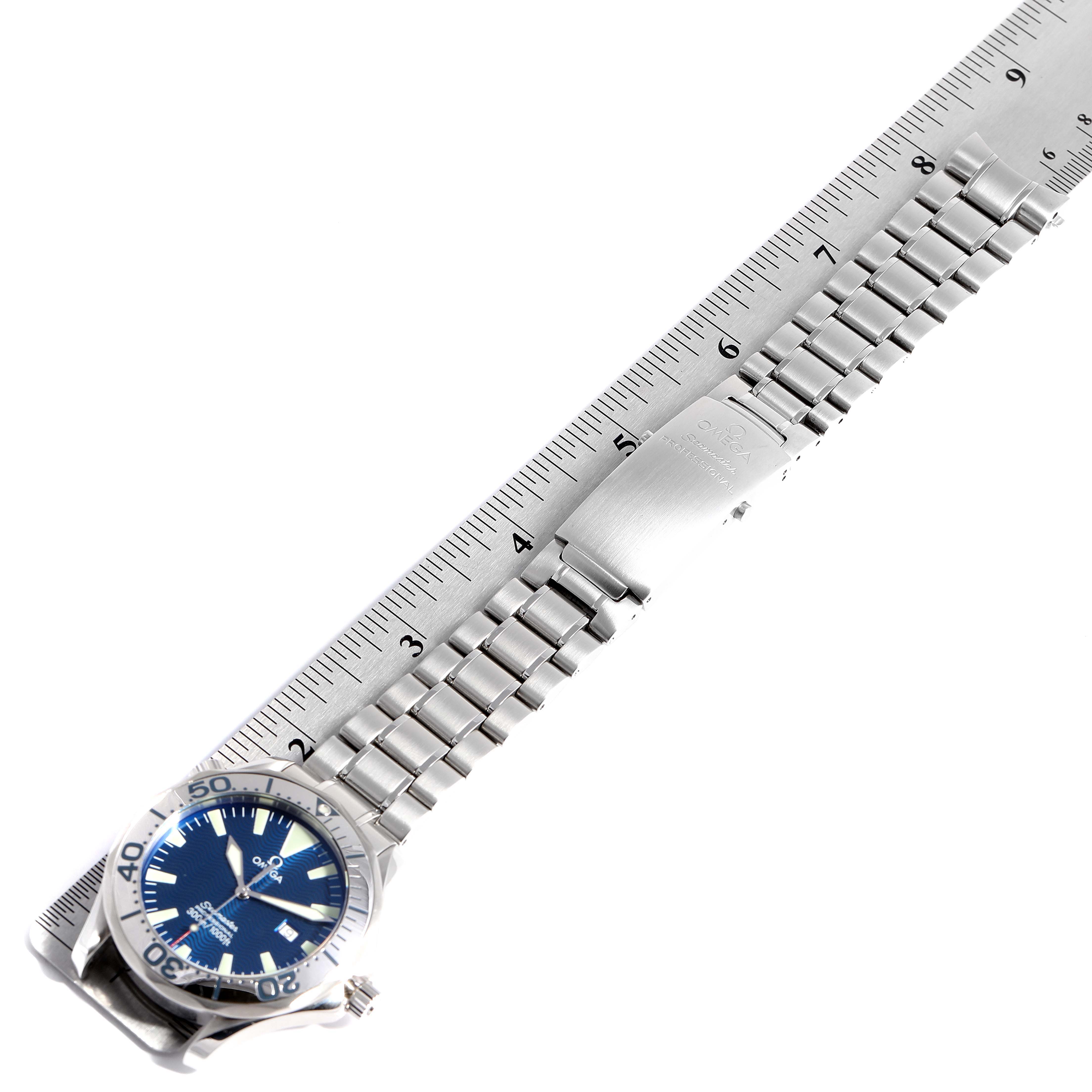 The image shows an Omega Seamaster 2265.80.00 Men
s Stainless Steel Blue Dial 2265.80.00 Men
s Stainless Steel Blue Dial watch with a stainless steel bracelet and clasp, measured against a ruler, from an overhead angle.