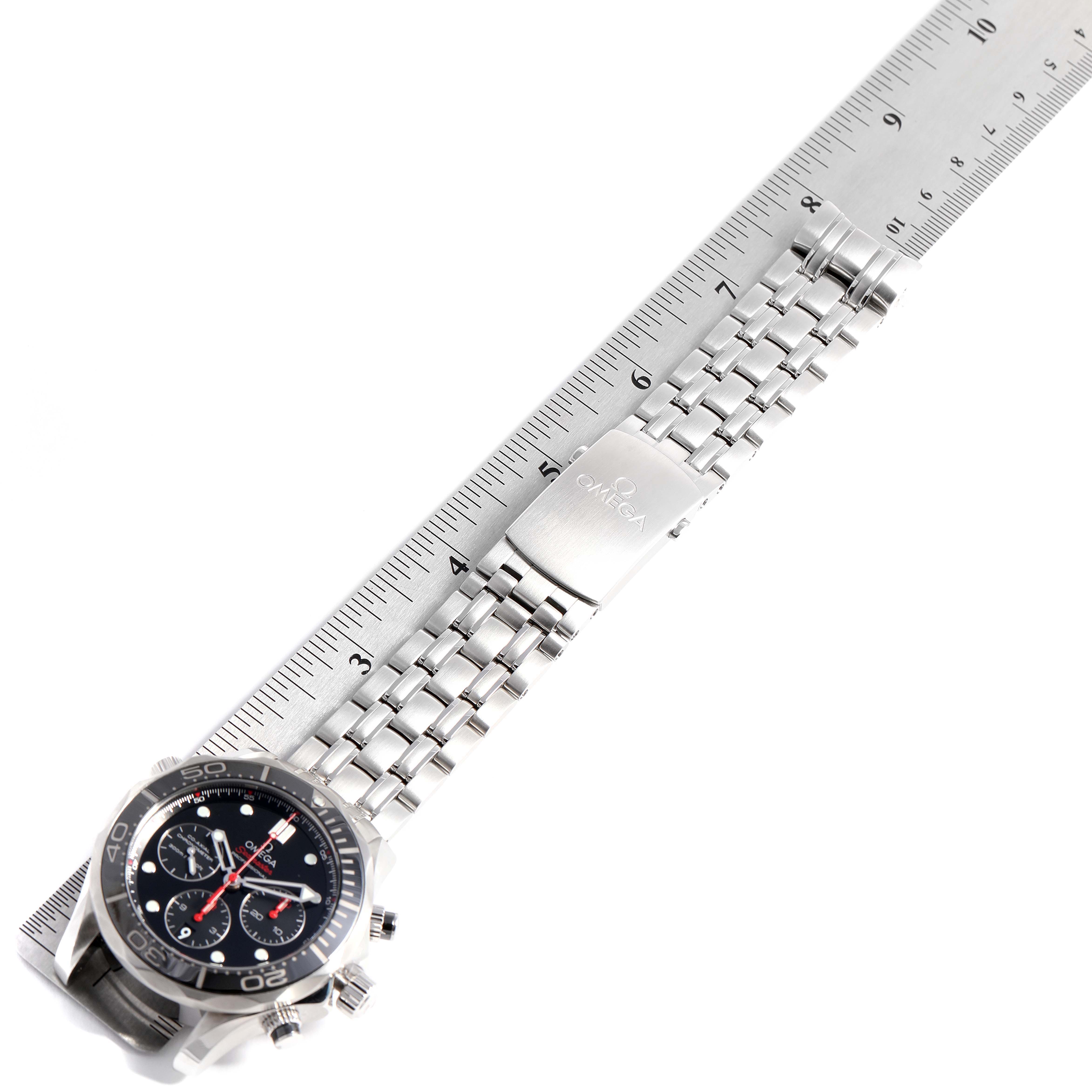 The image shows an Omega Seamaster 212.30.44.50.01.001 Men
s Stainless Steel Black Dial 212.30.44.50.01.001 Men
s Stainless Steel Black Dial watch laid flat with its bracelet measured against a ruler.