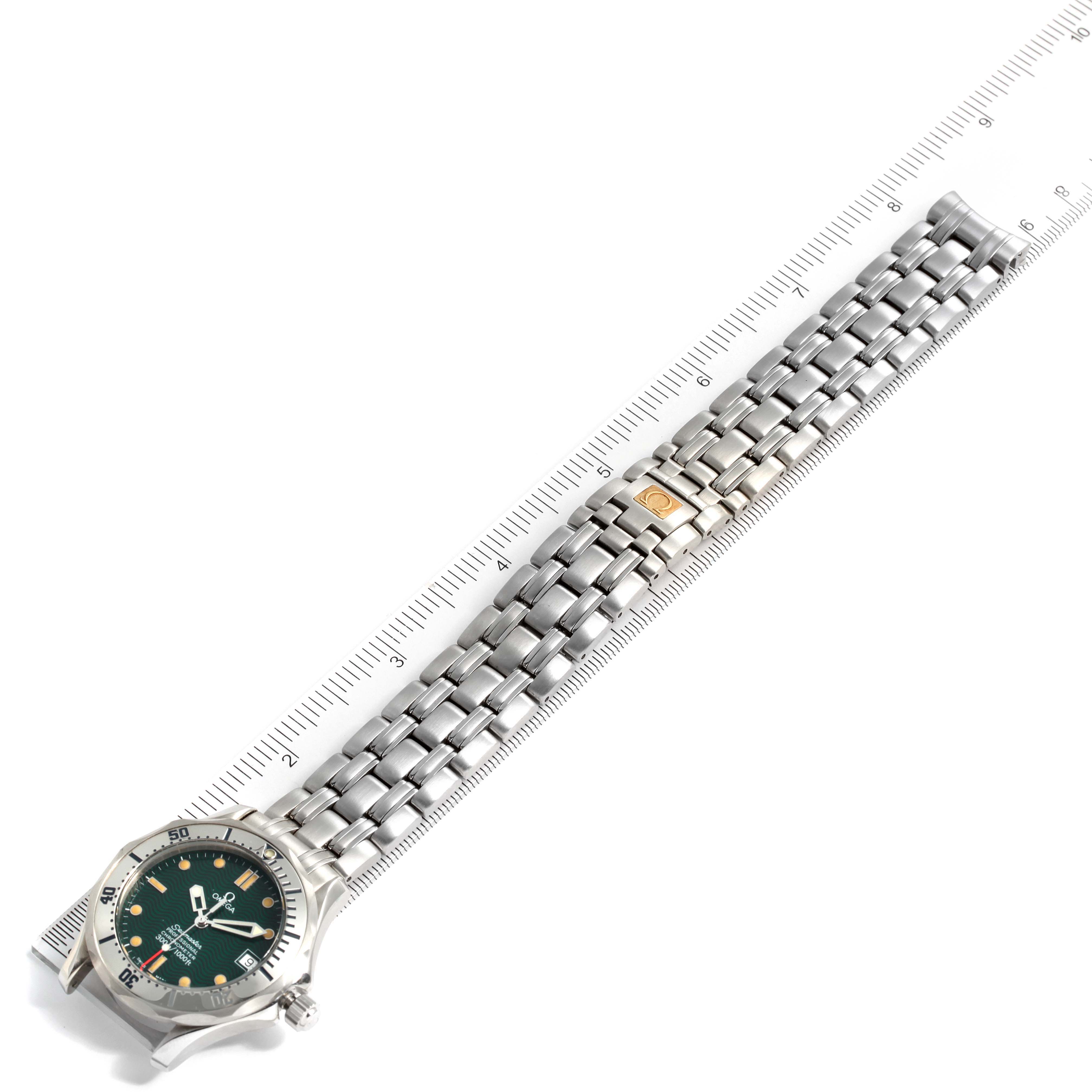 The image shows an Omega Seamaster 2553.41.00 Men's Stainless Steel Green Dial 2553.41.00 Men's Stainless Steel Green Dial watch laid flat, measured against a ruler, displaying both the face and the full metal bracelet.