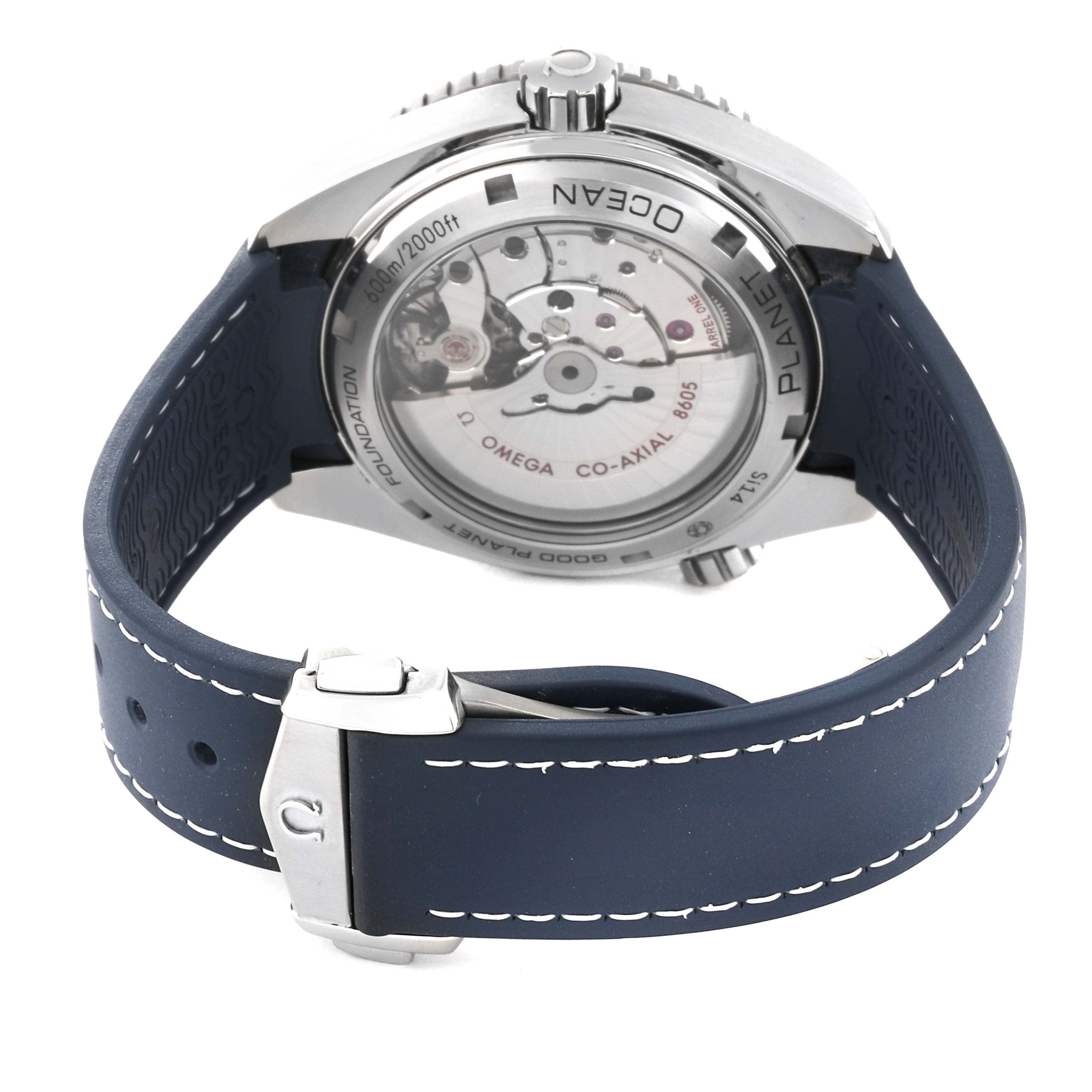 The image shows the back view of an Omega Planet Ocean 232.32.44.22.03.001 Men's Stainless Steel Blue Dial 232.32.44.22.03.001 Men's Stainless Steel Blue Dial watch, highlighting its transparent case back and strap with clasp.