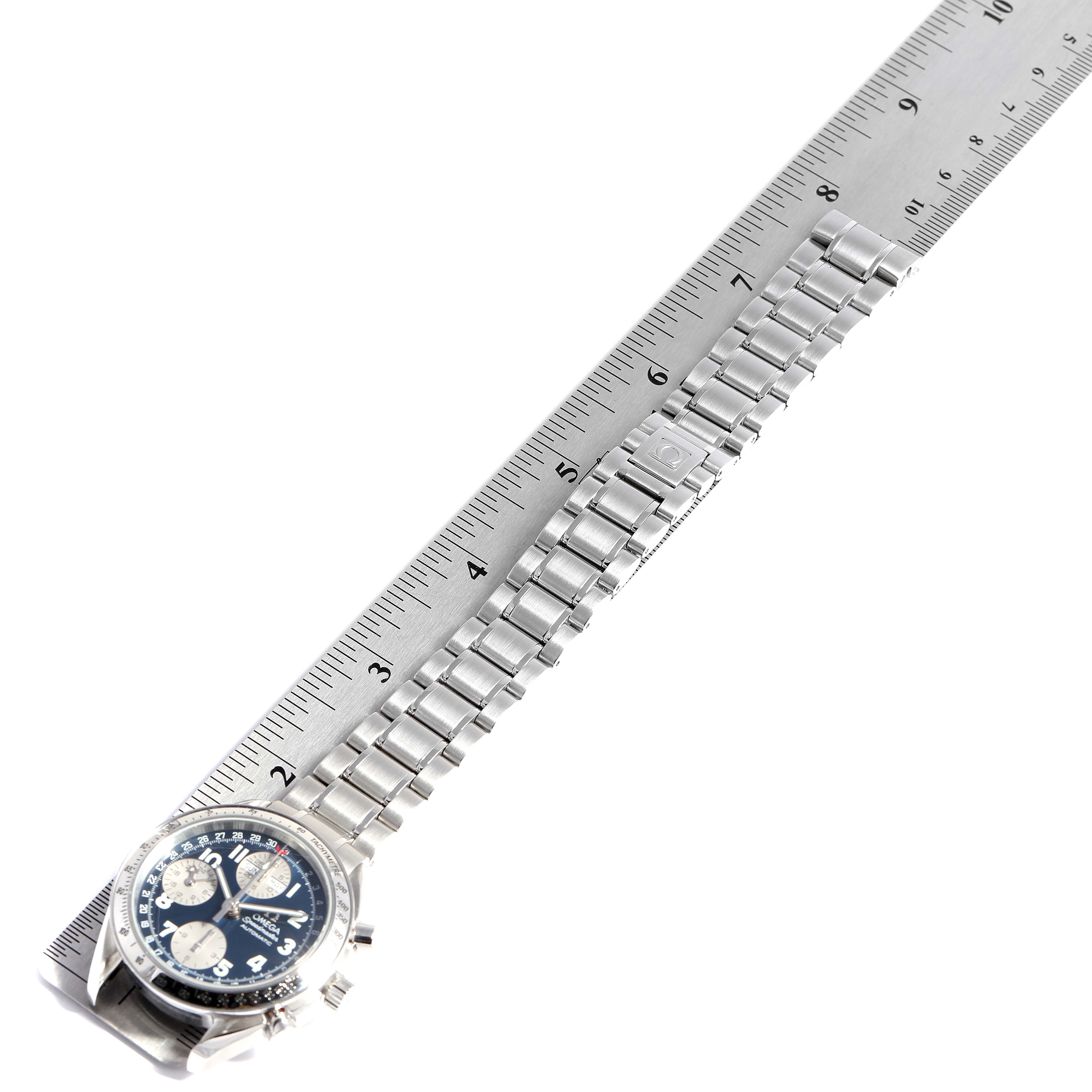 The Omega Speedmaster 3523.80.00 Men
s Stainless Steel Blue Dial 3523.80.00 Men
s Stainless Steel Blue Dial watch is shown from a top-down angle, alongside a ruler for measurement.