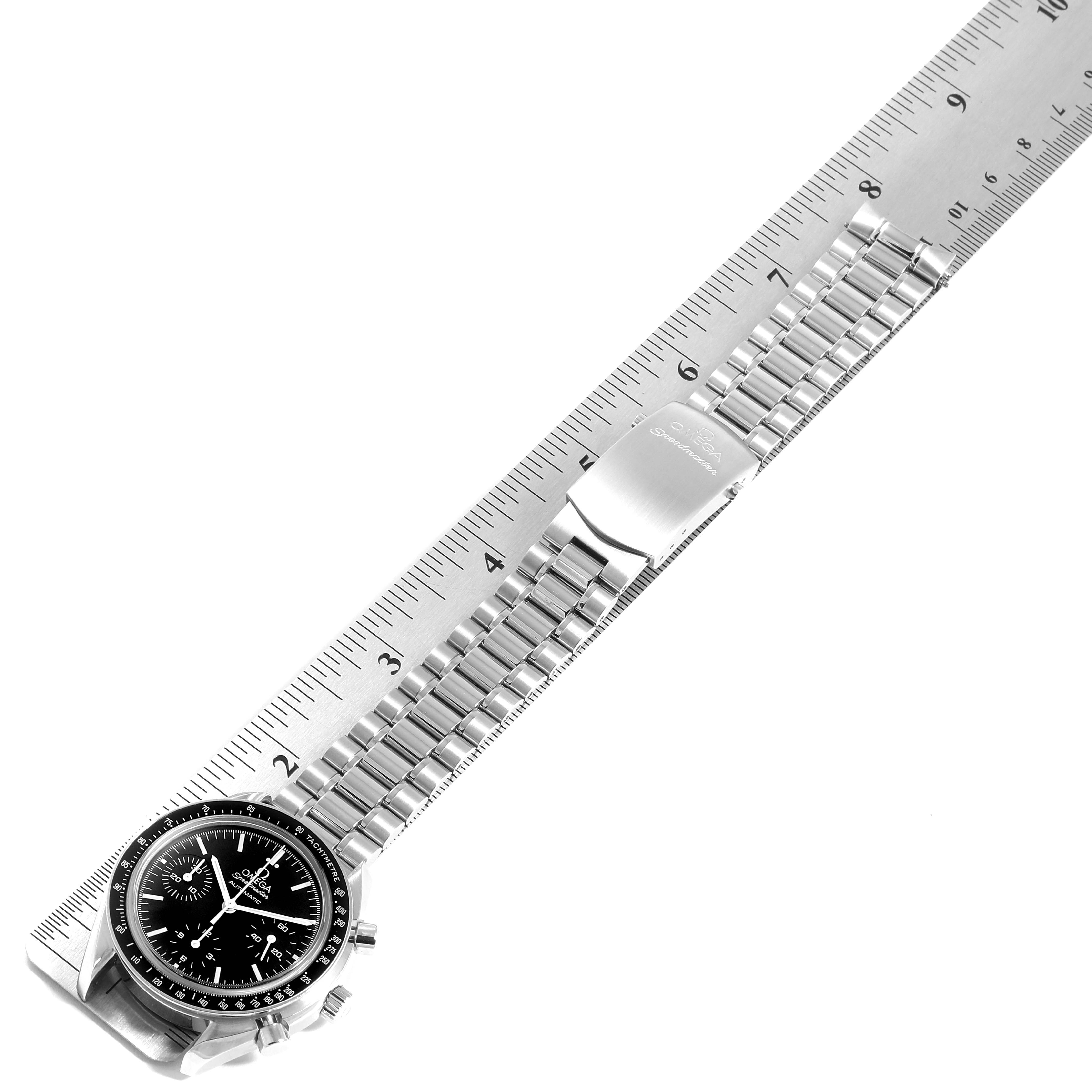 The Omega Speedmaster 3539.50.00 Men
s Stainless Steel Black Dial 3539.50.00 Men
s Stainless Steel Black Dial watch is shown lying flat with its bracelet extended alongside a ruler.