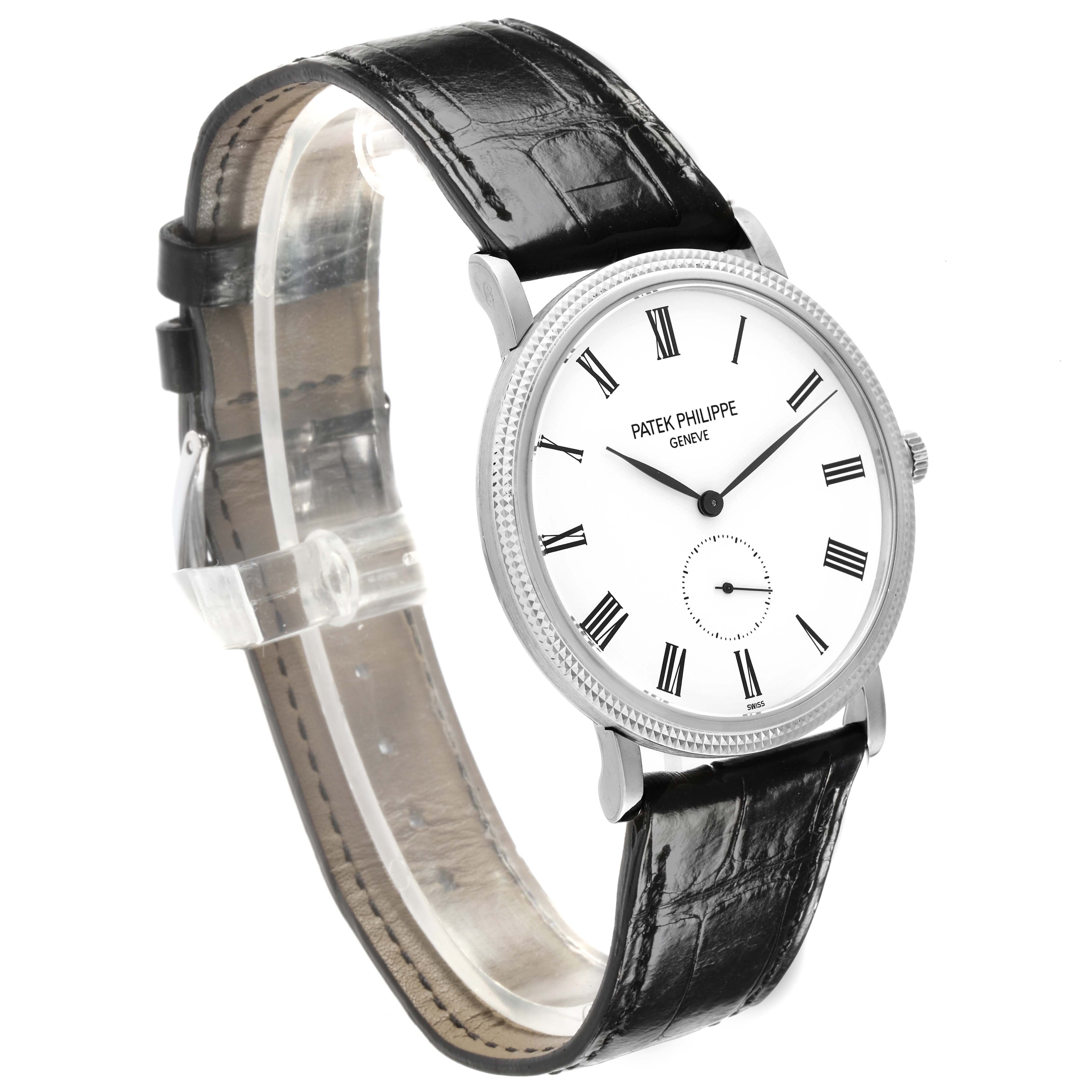 The Patek Philippe Calatrava 5119G-001 Men's White Gold White Dial watch is shown at a slight angle, displaying its face, leather strap, and crown.