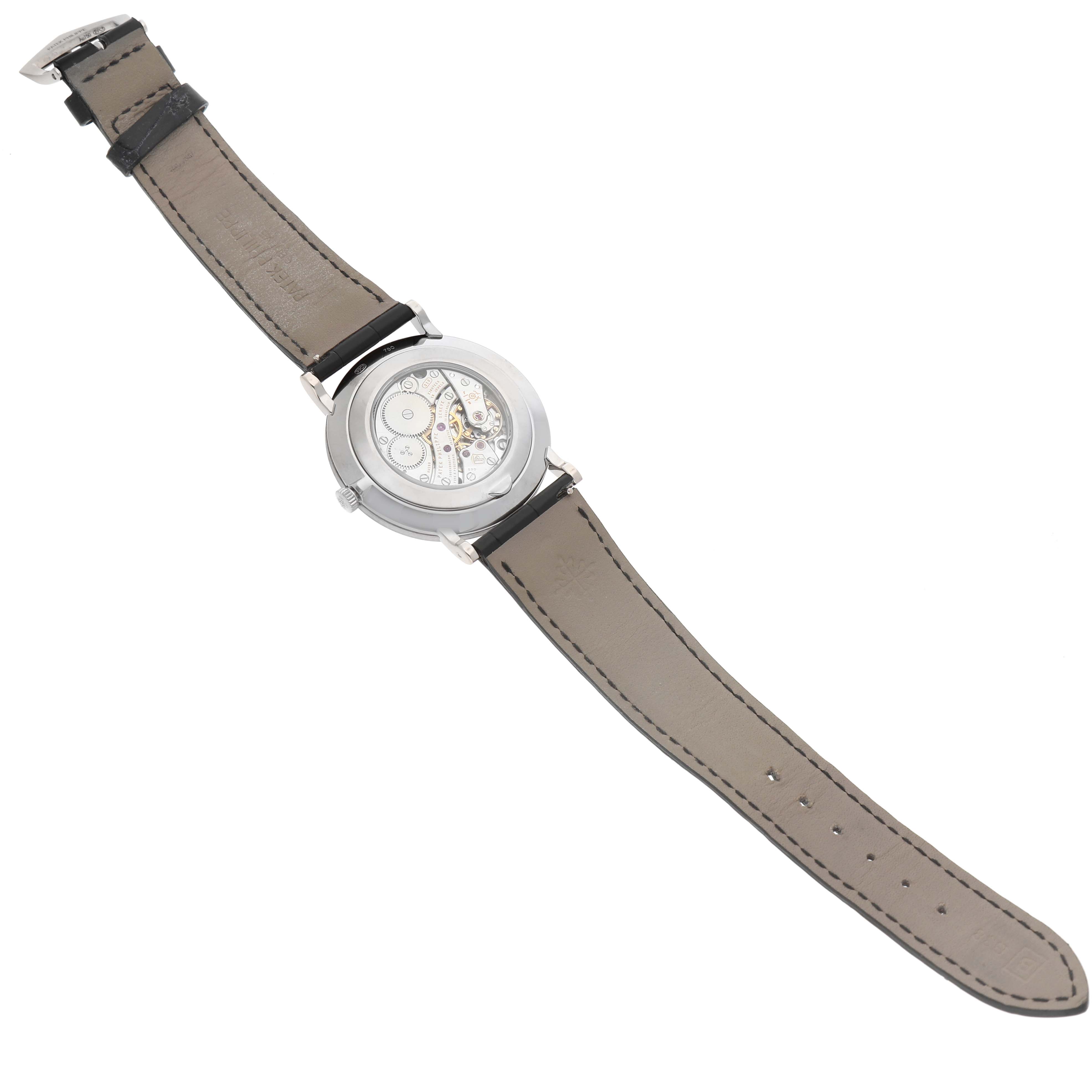 The Patek Philippe Calatrava 5119G-001 Men's White Gold White Dial watch is shown from the back at an angle, displaying its open case back and movement.