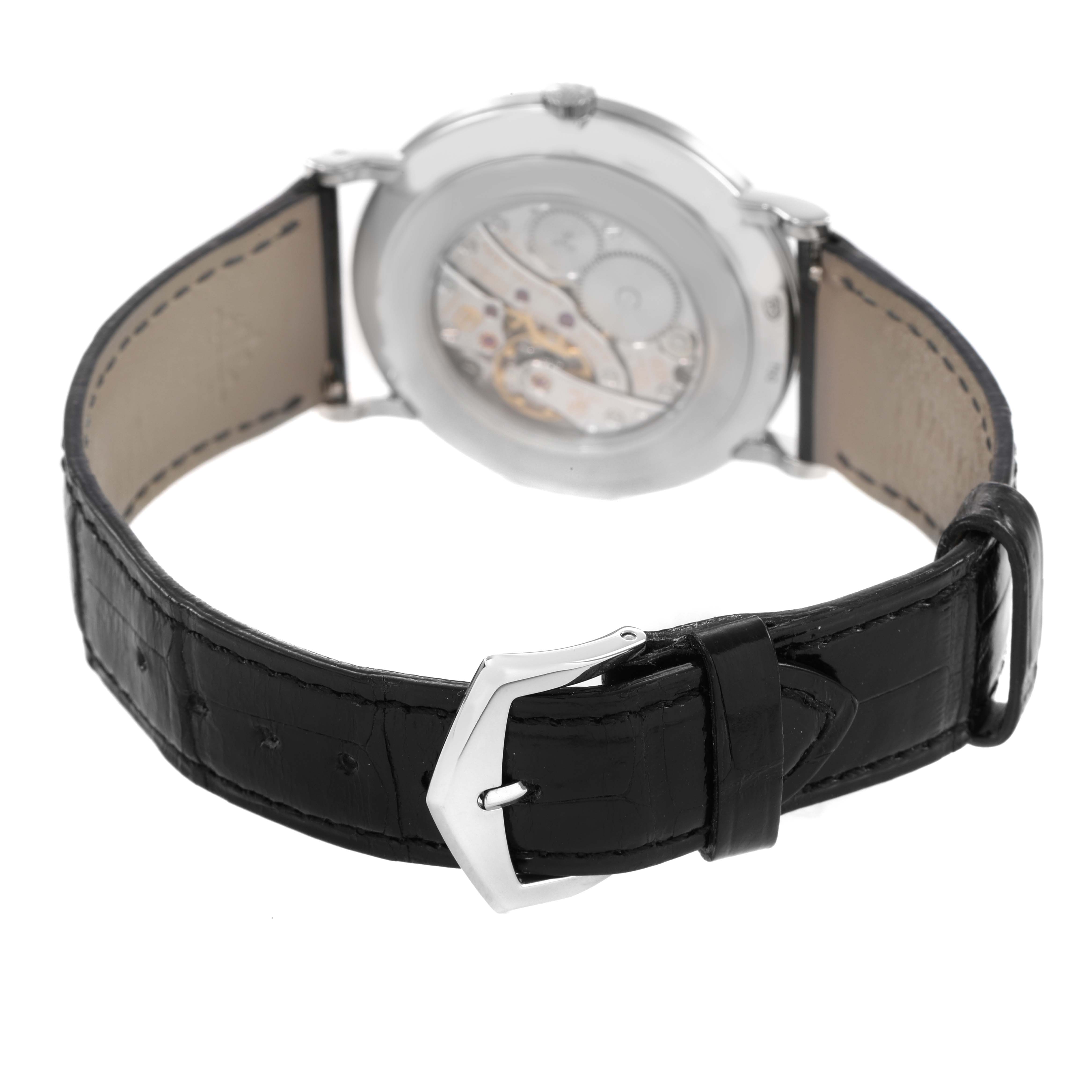 The Patek Philippe Calatrava 5119G-001 Men's White Gold White Dial watch is shown from a rear angle, highlighting the leather strap and transparent case back.