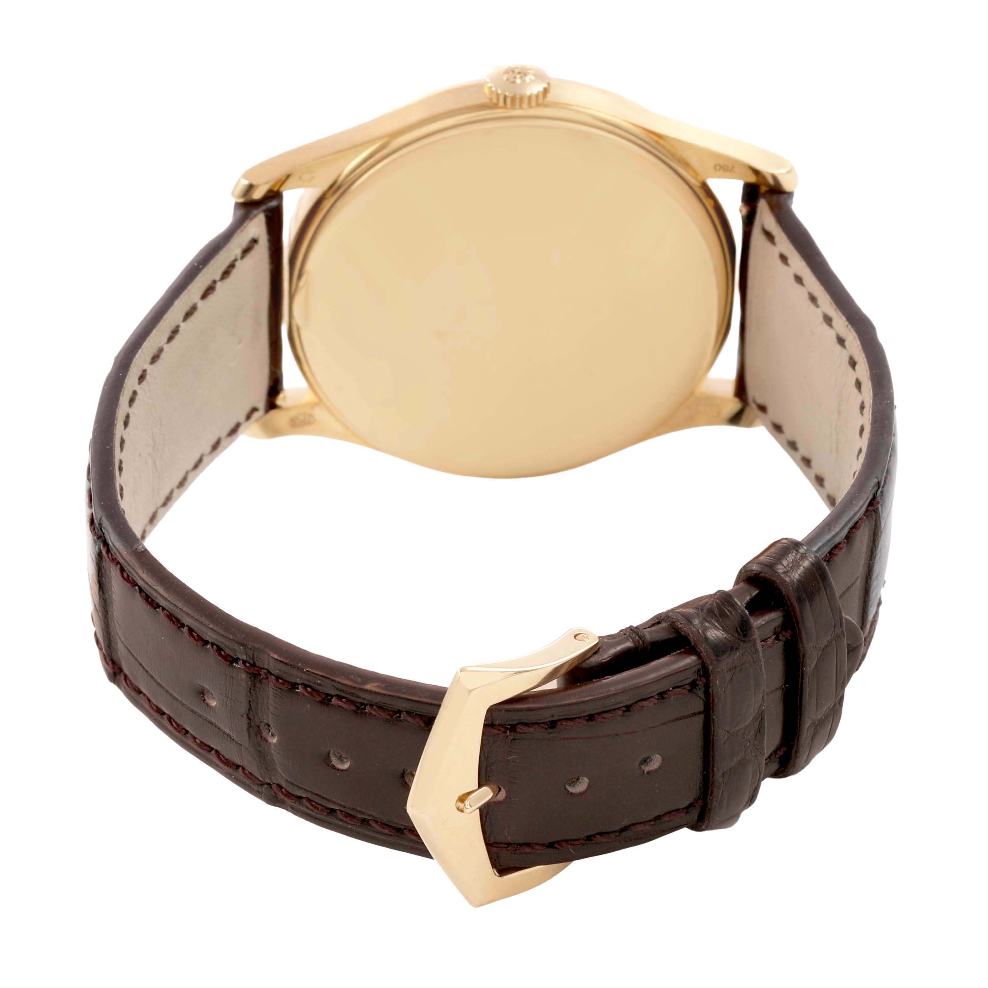 The Patek Philippe Calatrava 5196J Men's Yellow Gold Silver Dial watch is shown from the back, highlighting the case back, brown leather strap, and gold buckle.