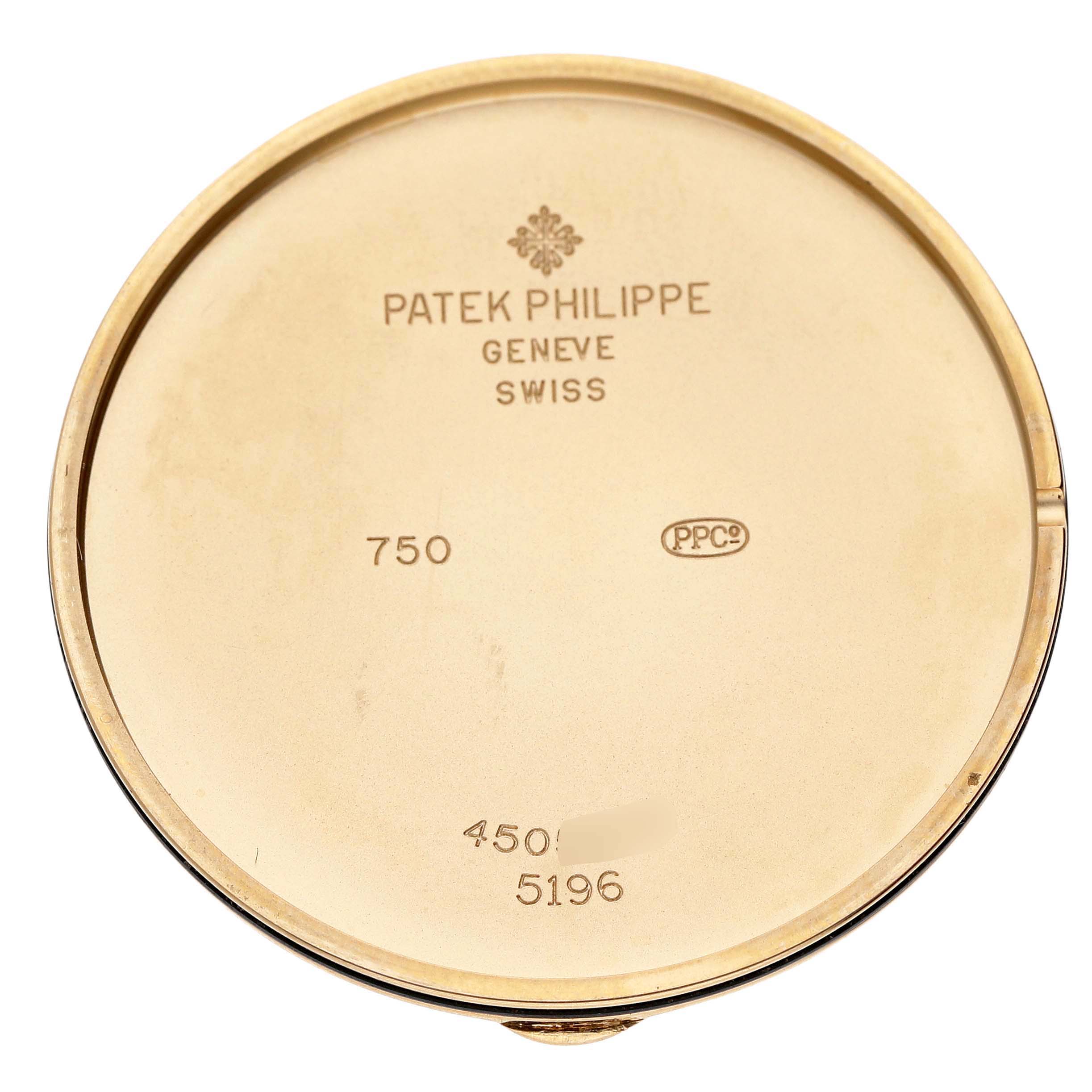 The back cover of the Patek Philippe Calatrava 5196J Men's Yellow Gold Silver Dial watch is shown, displaying engravings such as the brand and model number.