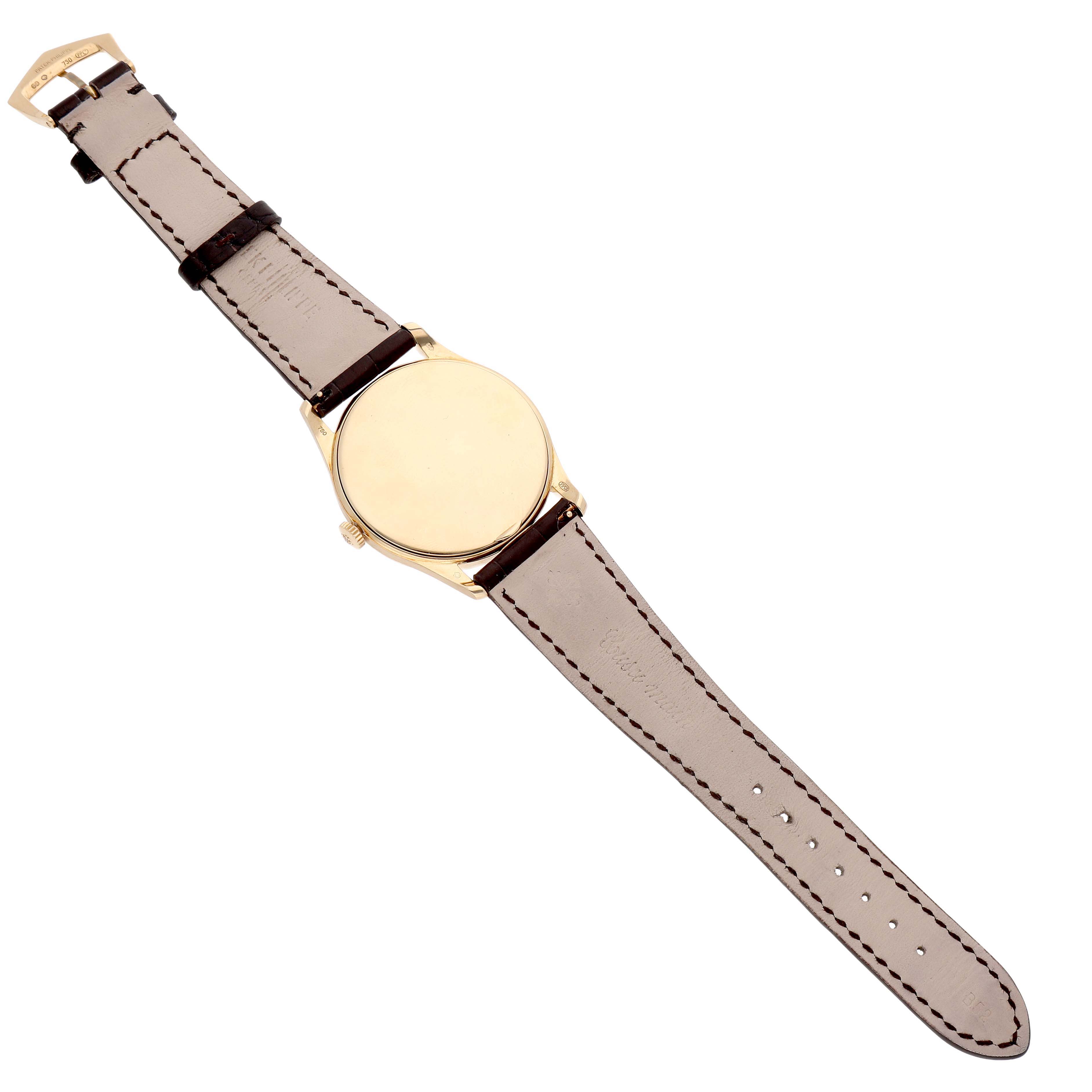 The image shows the Patek Philippe Calatrava 5196J Men's Yellow Gold Silver Dial watch from the back, featuring its leather strap and gold case.