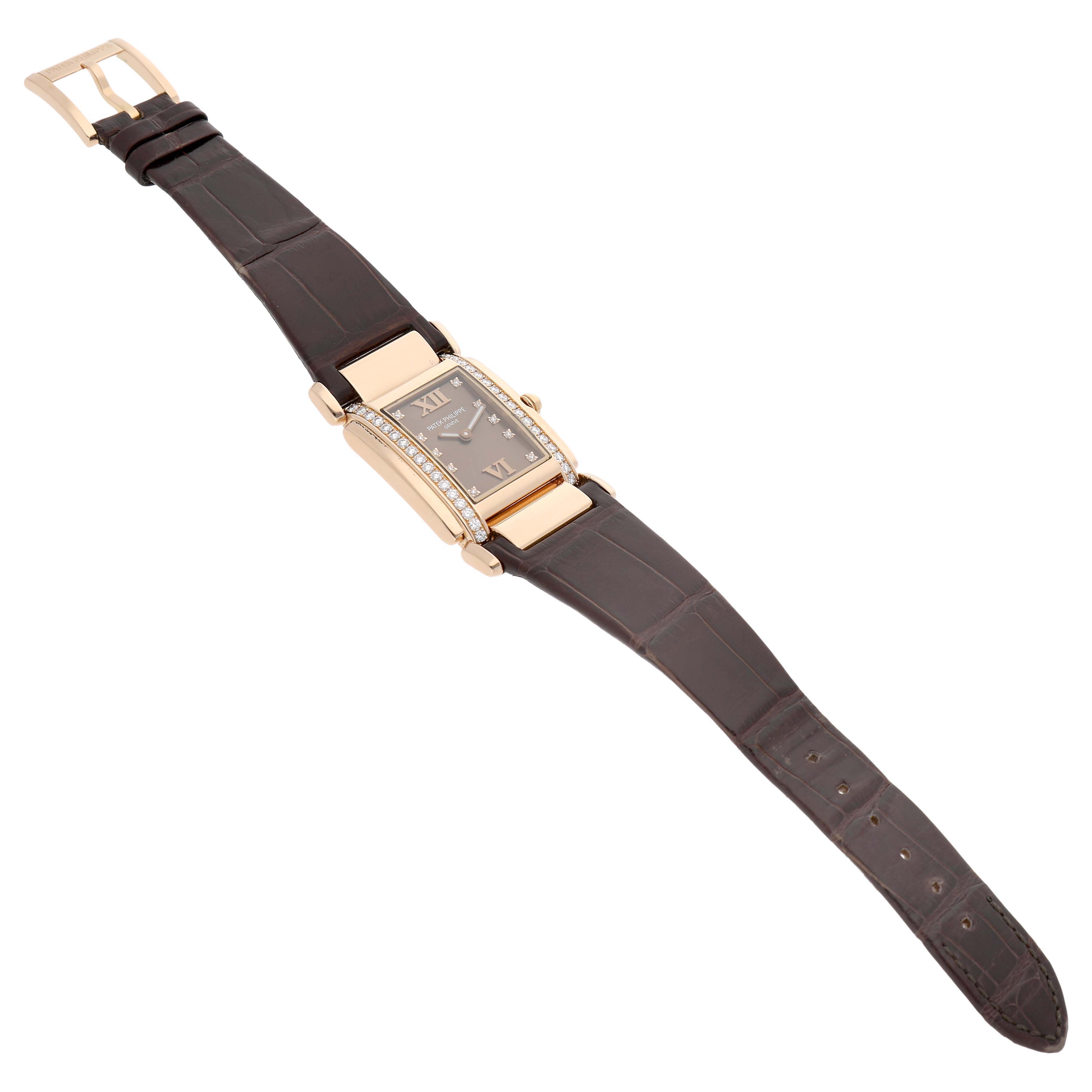 The Patek Philippe Twenty-4 4920R Women's Rose Gold Brown Dial watch is shown at a slight diagonal angle, displaying its rectangular face, diamond accents, and leather strap.