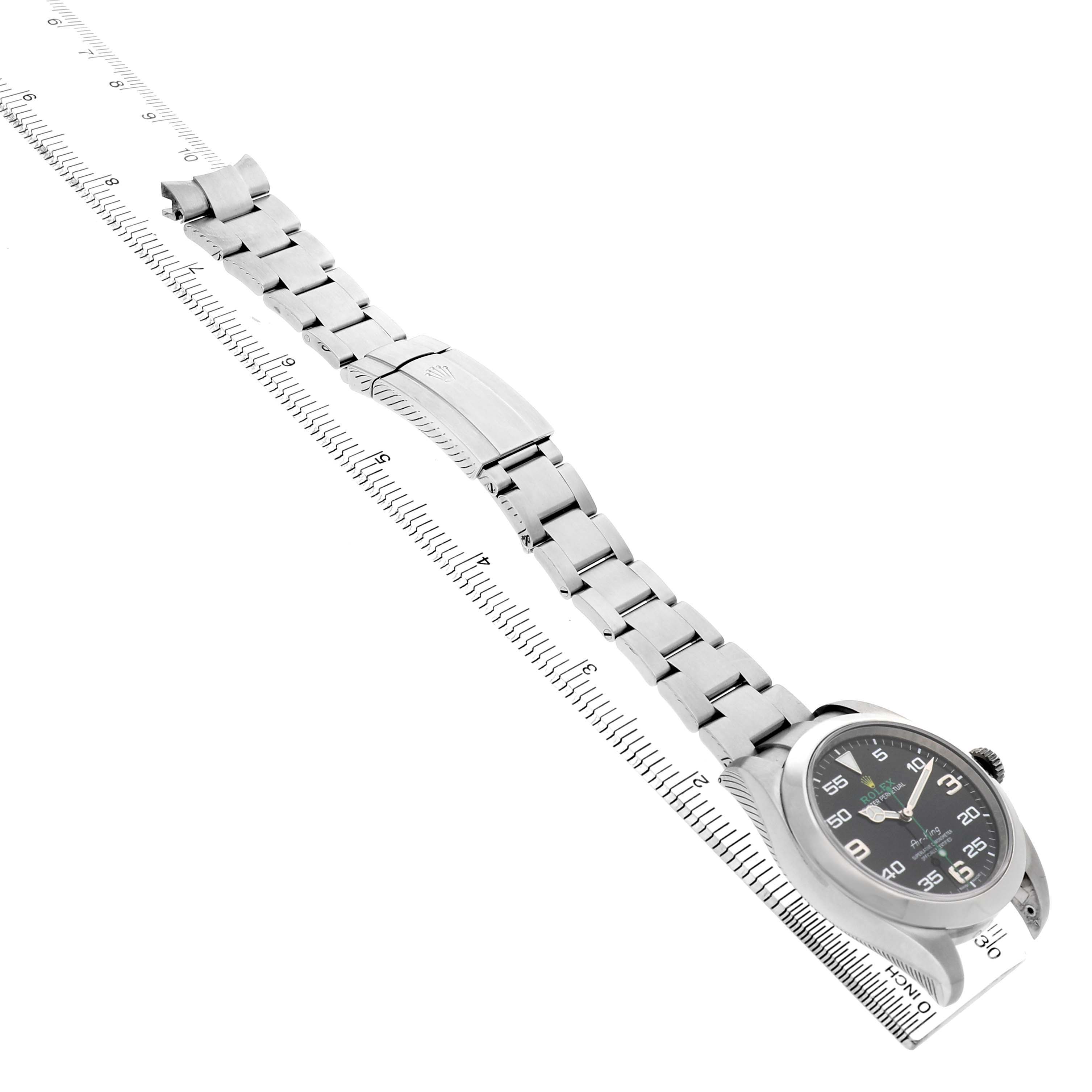The image shows a side angle of a Rolex Air-King 116900 Men's Stainless Steel Black Dial, highlighting the bracelet, clasp, and watch face.