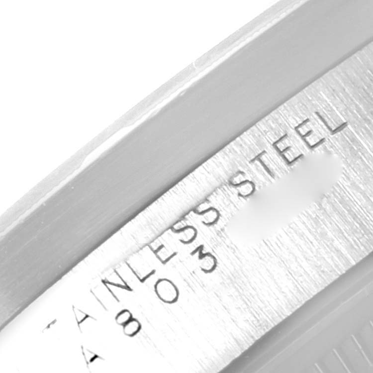 This close-up image shows the "Stainless Steel" engraving on the side of the Rolex Date 15210 Men's Stainless Steel Blue Dial 15210 Men's Stainless Steel Blue Dial model.