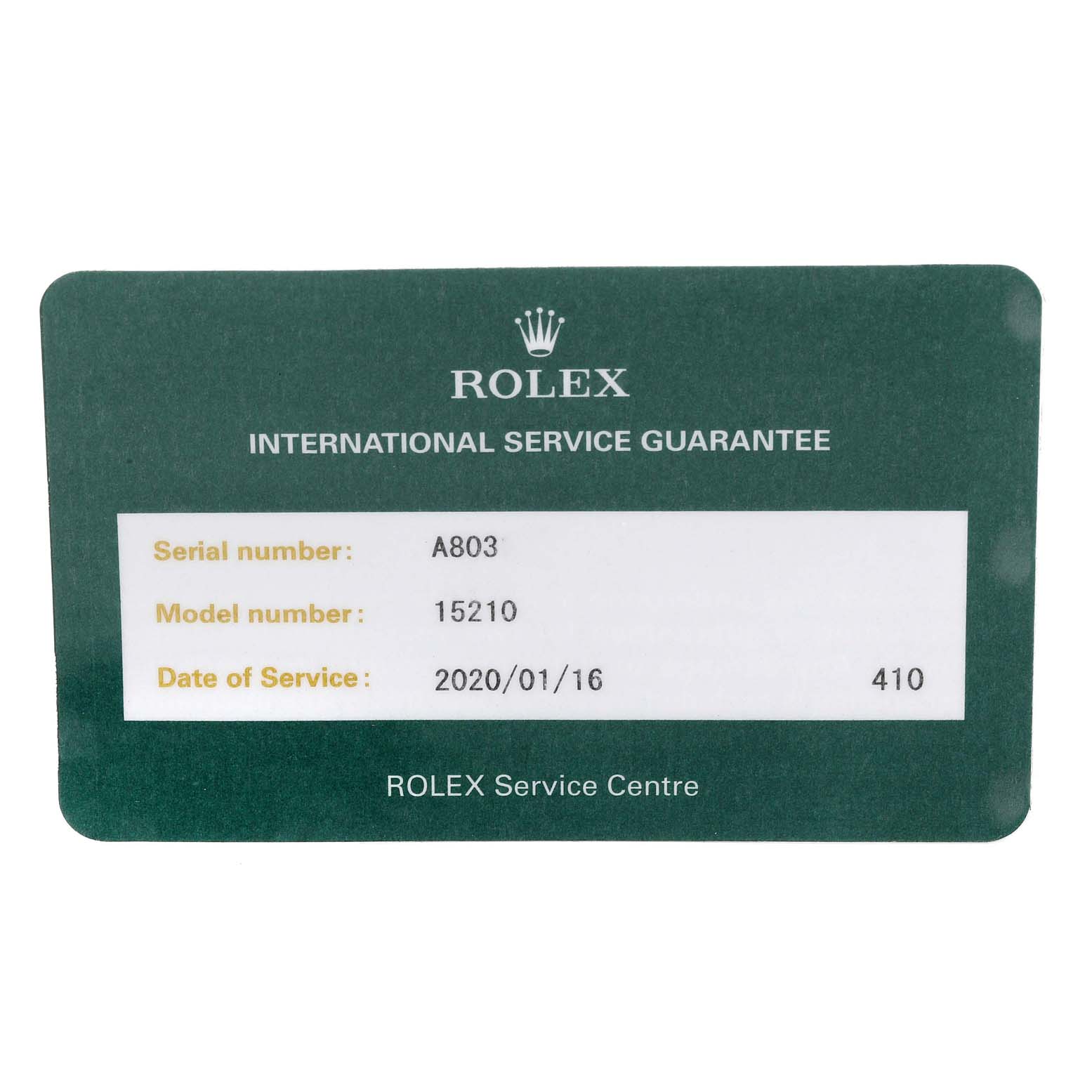 The image shows a green International Service Guarantee card for the Rolex Date 15210 Men's Stainless Steel Blue Dial 15210 Men's Stainless Steel Blue Dial model with details on service and serial number.