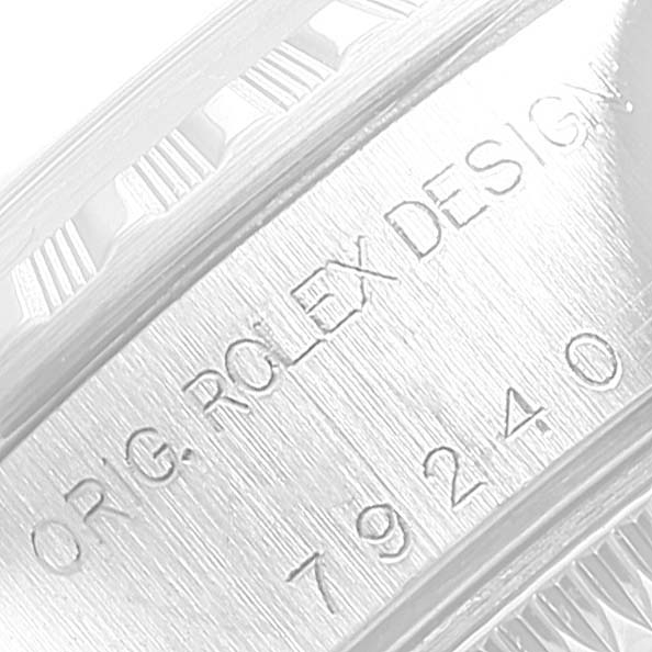 The image shows an extreme close-up of the case side and engraving on a Rolex Date 79240 Women's Stainless Steel Blue Dial 79240 Women's Stainless Steel Blue Dial model watch.