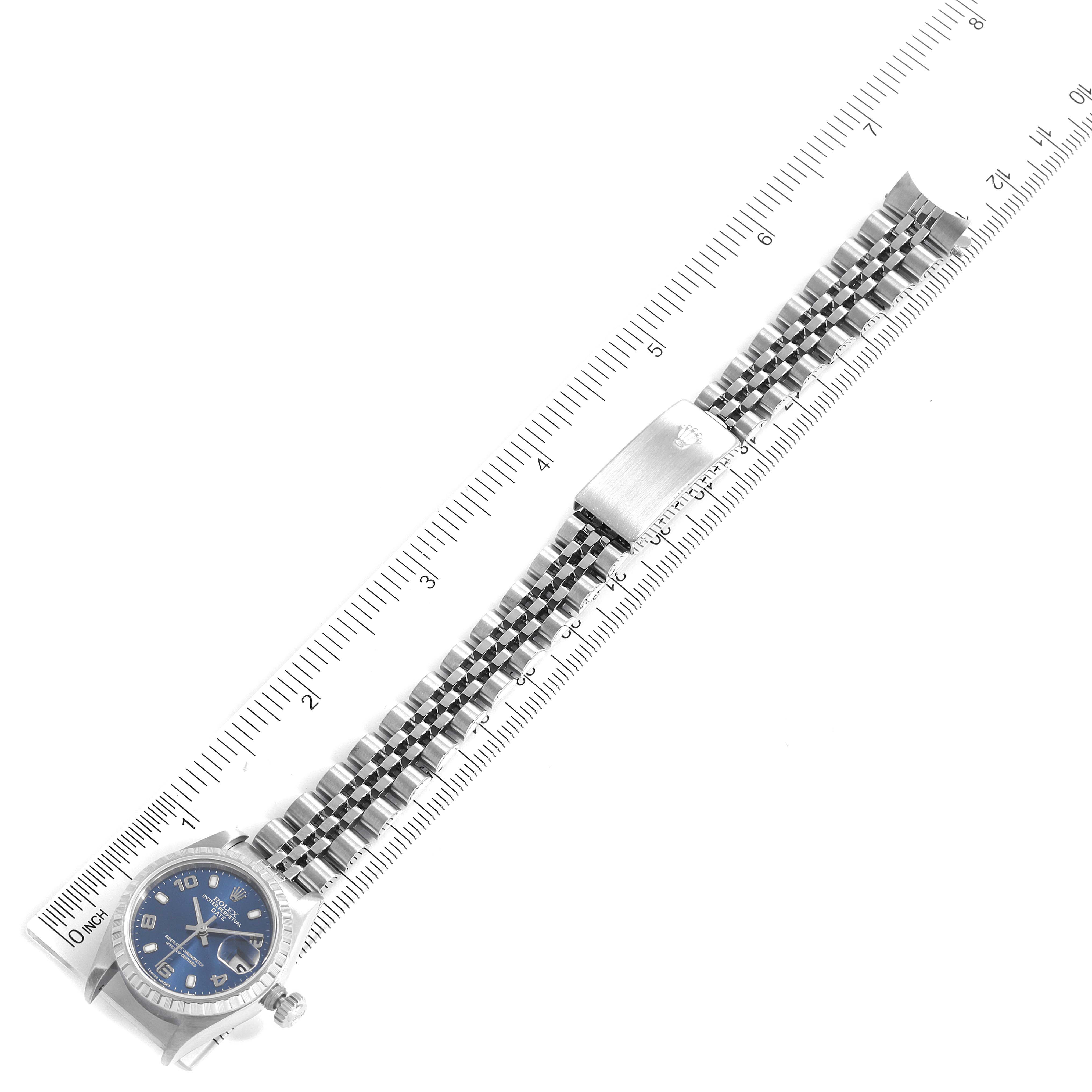 The image shows a top-down view of a Rolex Date 79240 Women's Stainless Steel Blue Dial 79240 Women's Stainless Steel Blue Dial model watch with a visible dial, bracelet, and clasp placed beside a ruler.