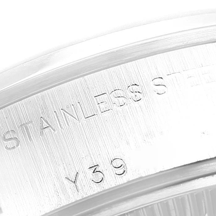 This is a close-up shot of the bezel on a Rolex Date 79160 Women's Stainless Steel Silver Dial 79160 Women's Stainless Steel Silver Dial model watch, highlighting the inscription "STAINLESS STEEL".