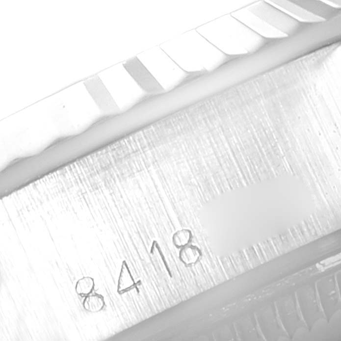 This image shows a close-up angle of the serial number engraving on a Rolex Date 69174 Women's Stainless Steel Silver Dial 69174 Women's Stainless Steel Silver Dial model watch.