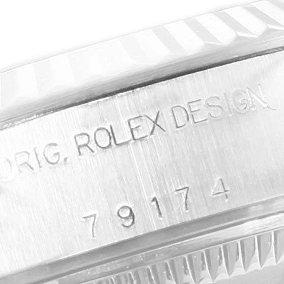 The image shows a close-up of the engraved case with serial number details on a Datejust model by Rolex.