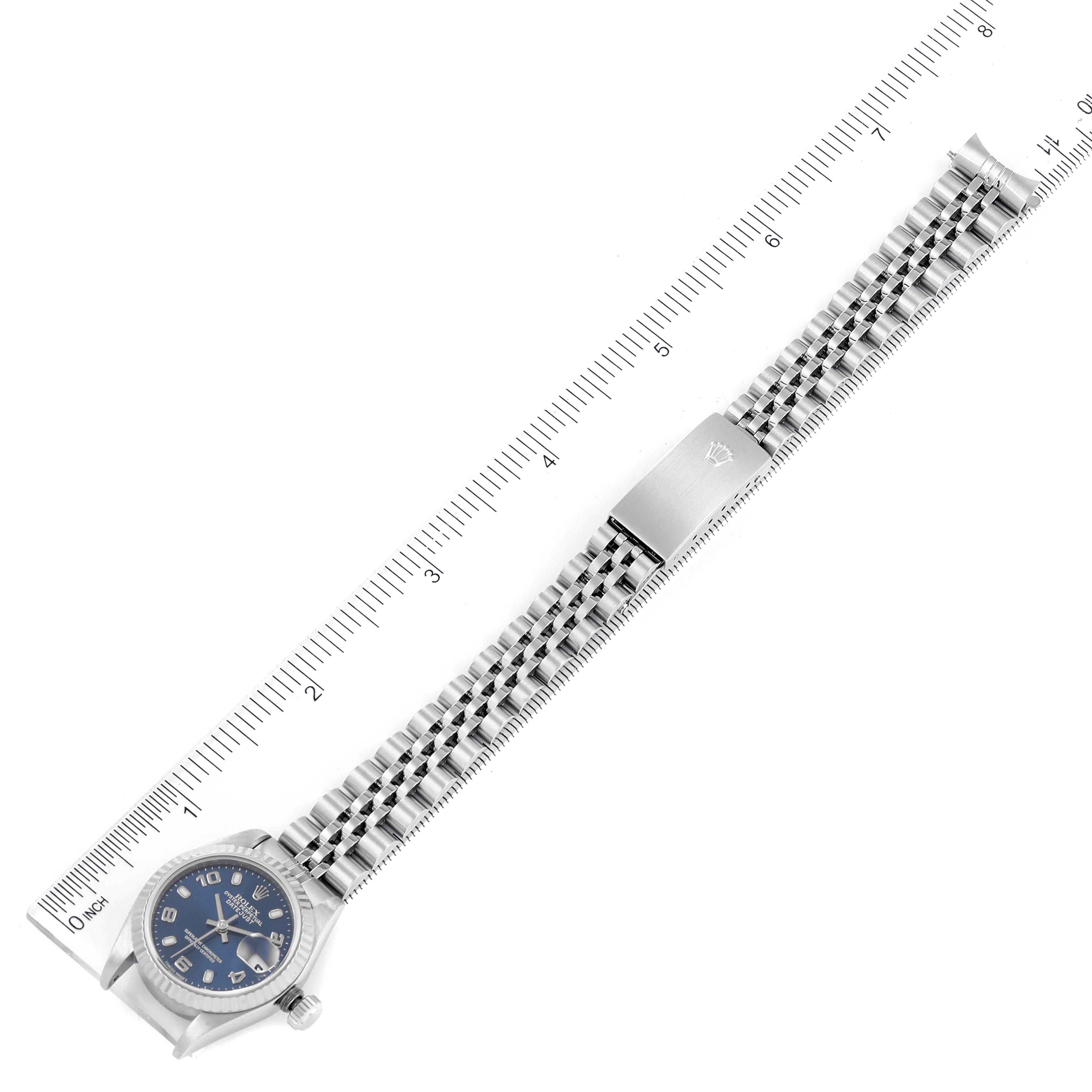 The image shows a top-down view of a Rolex Datejust 79174 Women
s Stainless Steel Blue Dial 79174 Women
s Stainless Steel Blue Dial watch with its bracelet laid flat against a ruler for measurement.