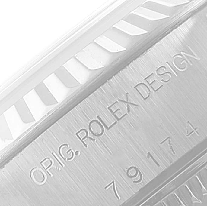 This image shows a close-up of the side of a Rolex Datejust 79174 Women
s Stainless Steel Silver Dial 79174 Women
s Stainless Steel Silver Dial watch, highlighting the "ORIG. ROLEX DESIGN" engraving.