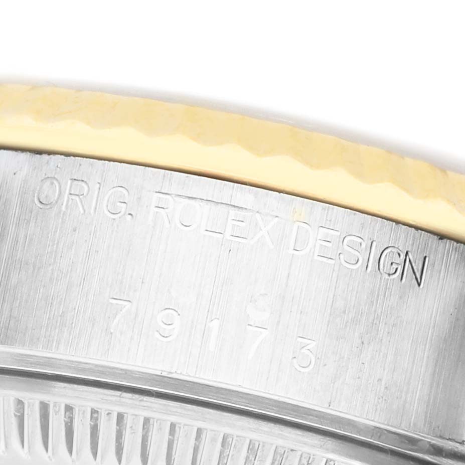 This close-up image shows the side of a Rolex Datejust 79173 Women's Steel and Gold (two tone) Champagne Dial watch, focusing on the engraved model details on the case.