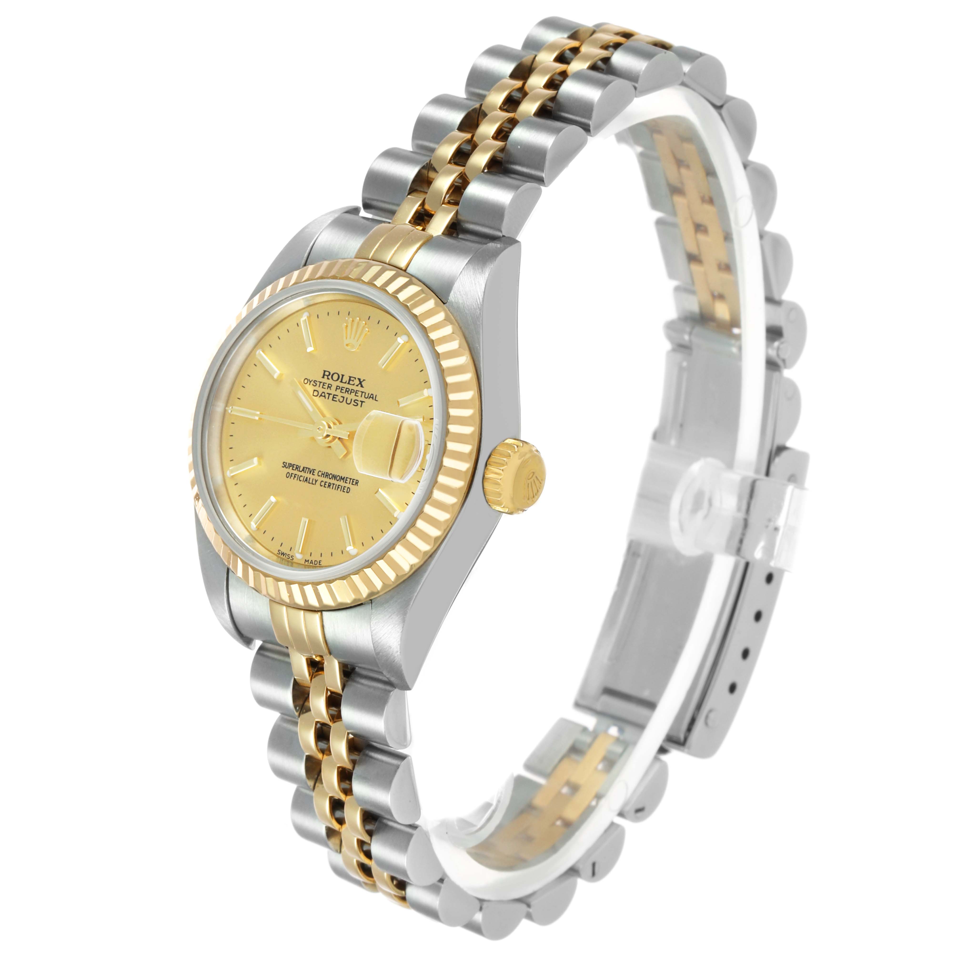 The Rolex Datejust 79173 Women's Steel and Gold (two tone) Champagne Dial watch is shown at a three-quarter angle, displaying its gold bezel, dial, and two-tone bracelet.